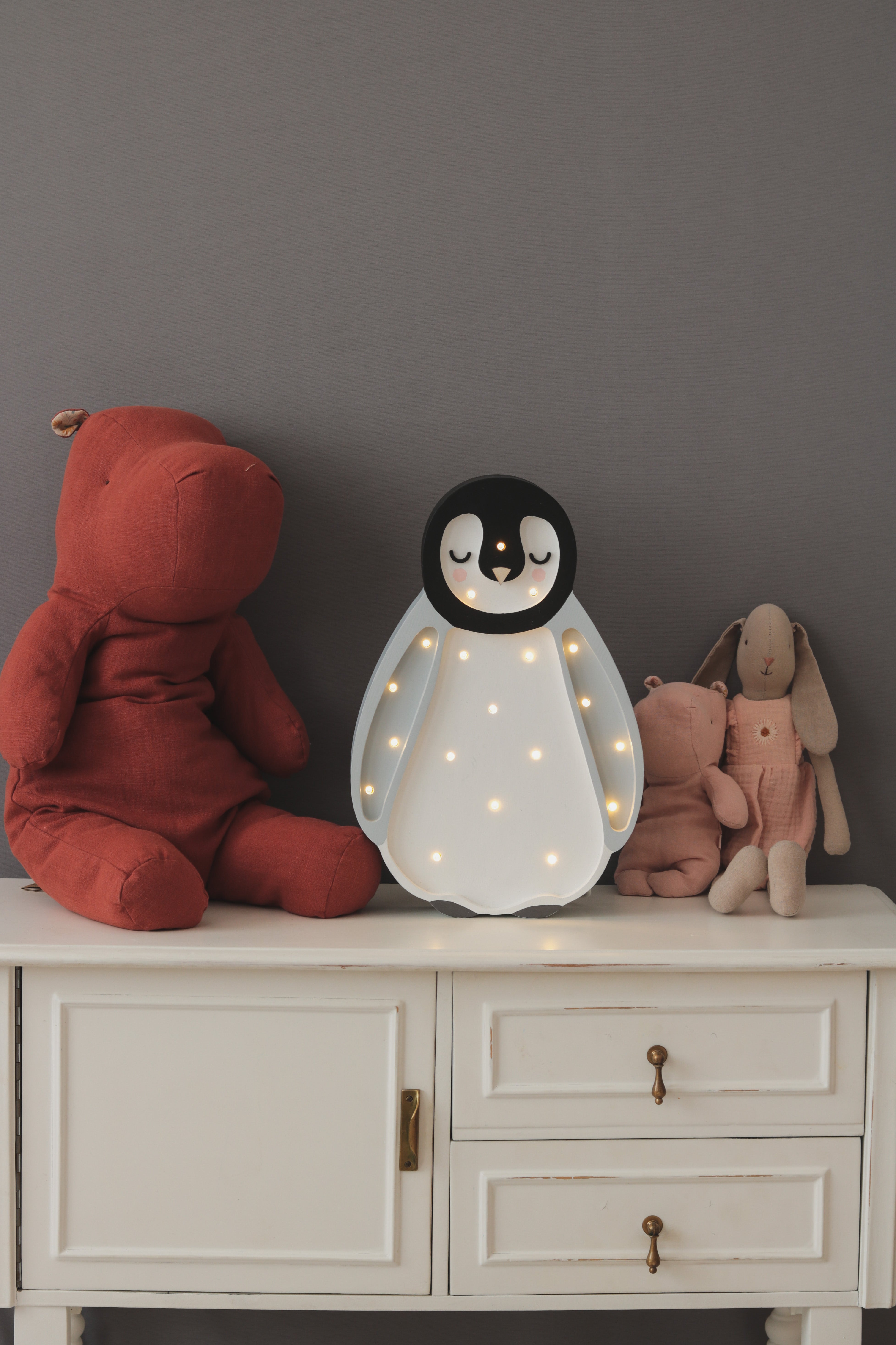 Gray handmade penguin nightlight by Little Lights with dimmable LED and remote control.