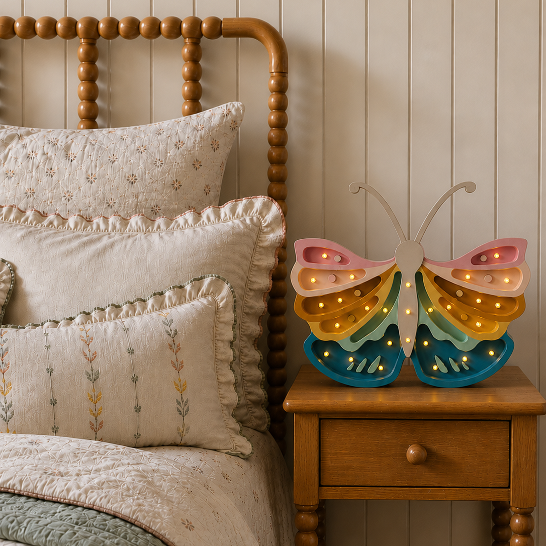 Little Lights Butterfly retro rainbow lamp glowing on a night stand in a girl's bedroom