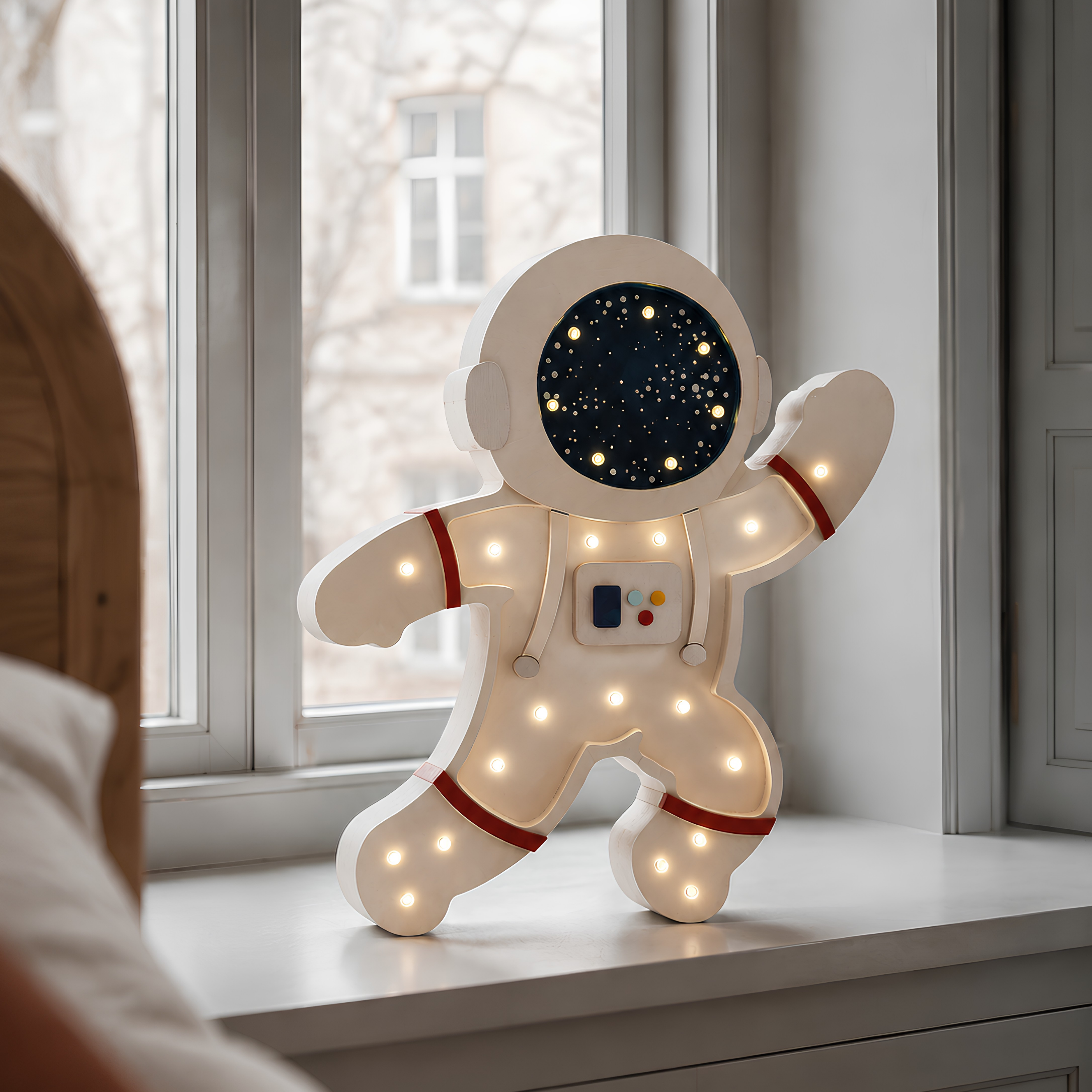 Little Lights Astronaut Lamp by the bed in a kid's room
