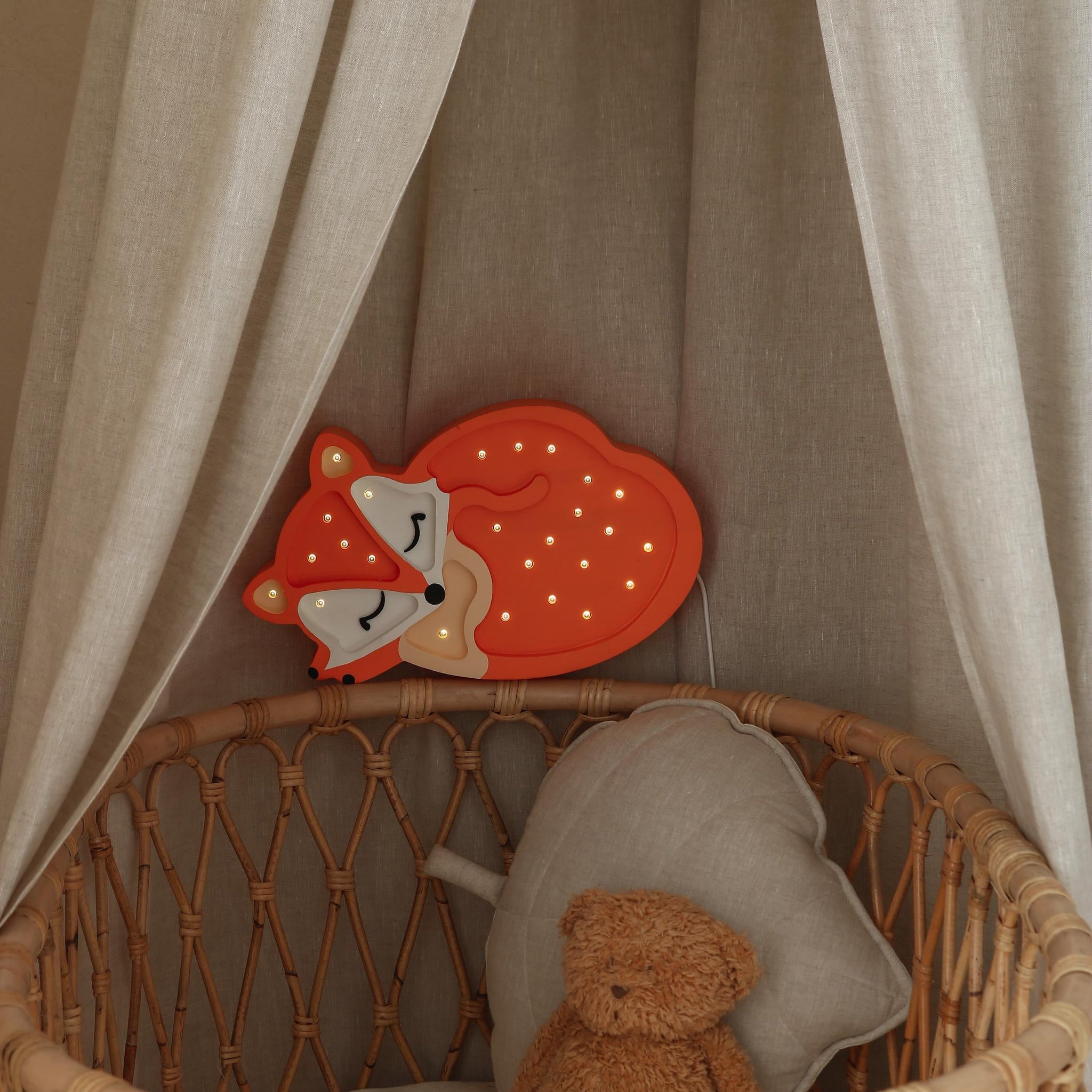 Wooden Little Lighyts fox night light above a crib in a baby nursery