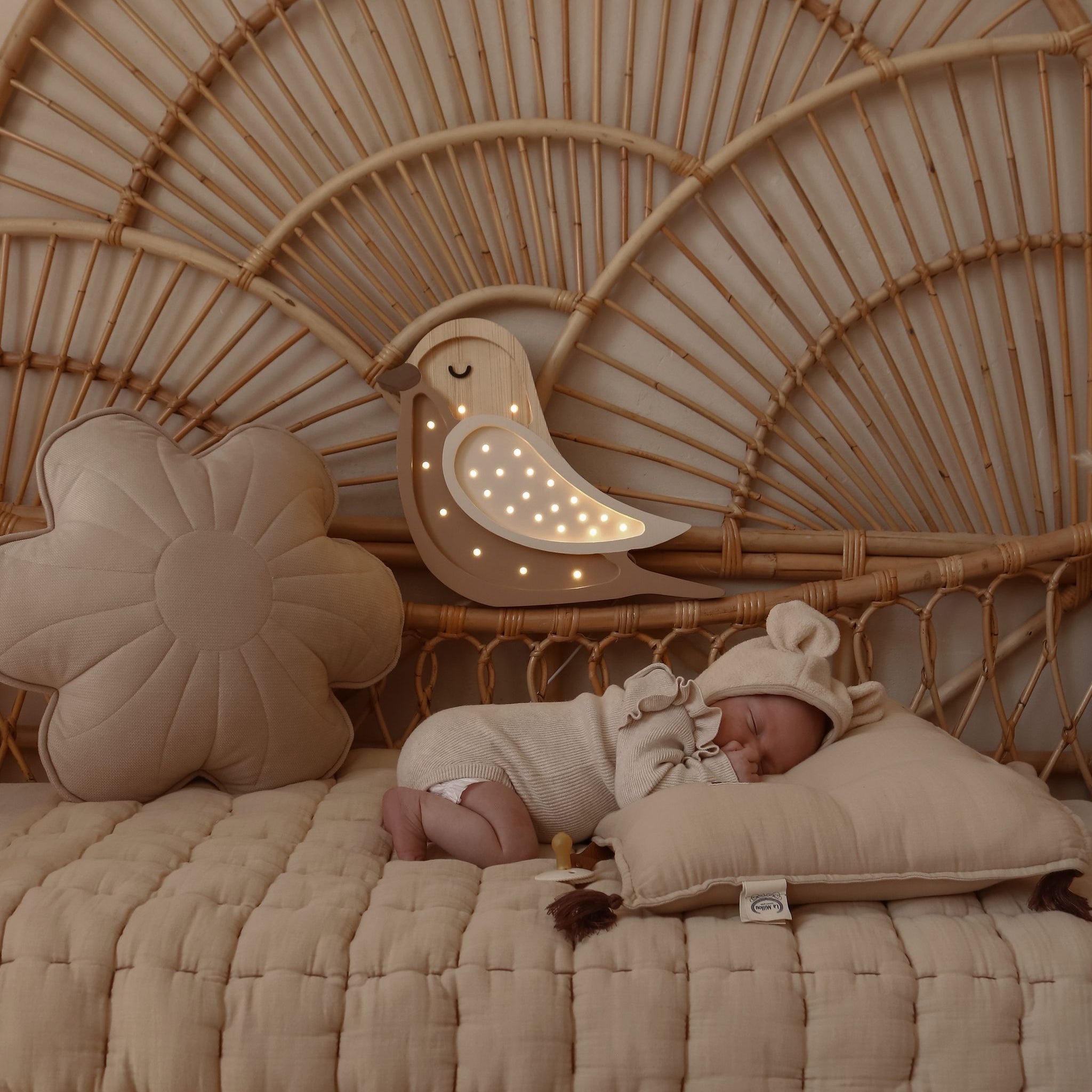 Little Lights Bird Lamp next to a sleeping baby