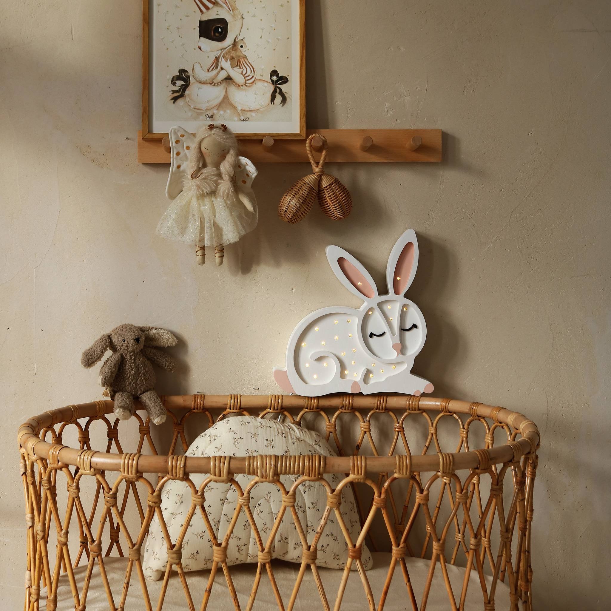 Little Lights Bunny Night Light next to a crib in a baby nursery
