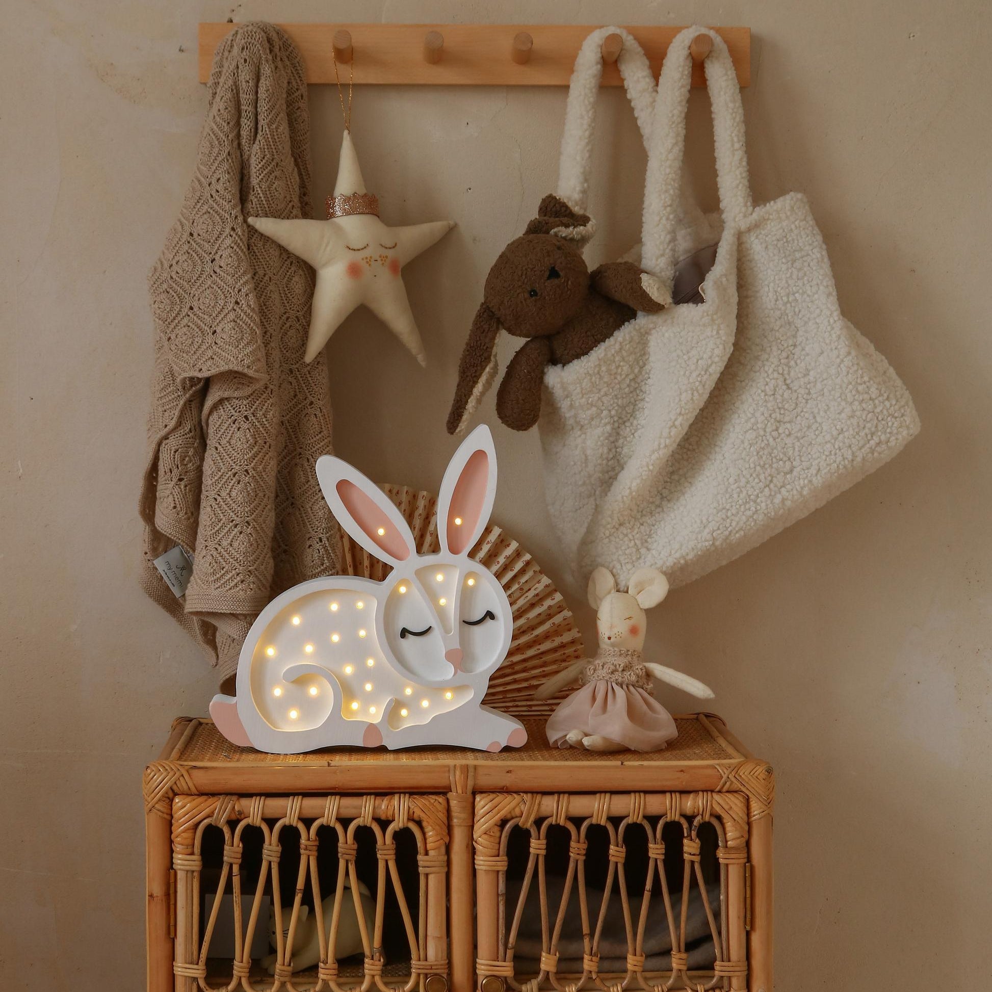 Little Lights white Bunny lamp on a wicker cabinet in a baby girl nursery
