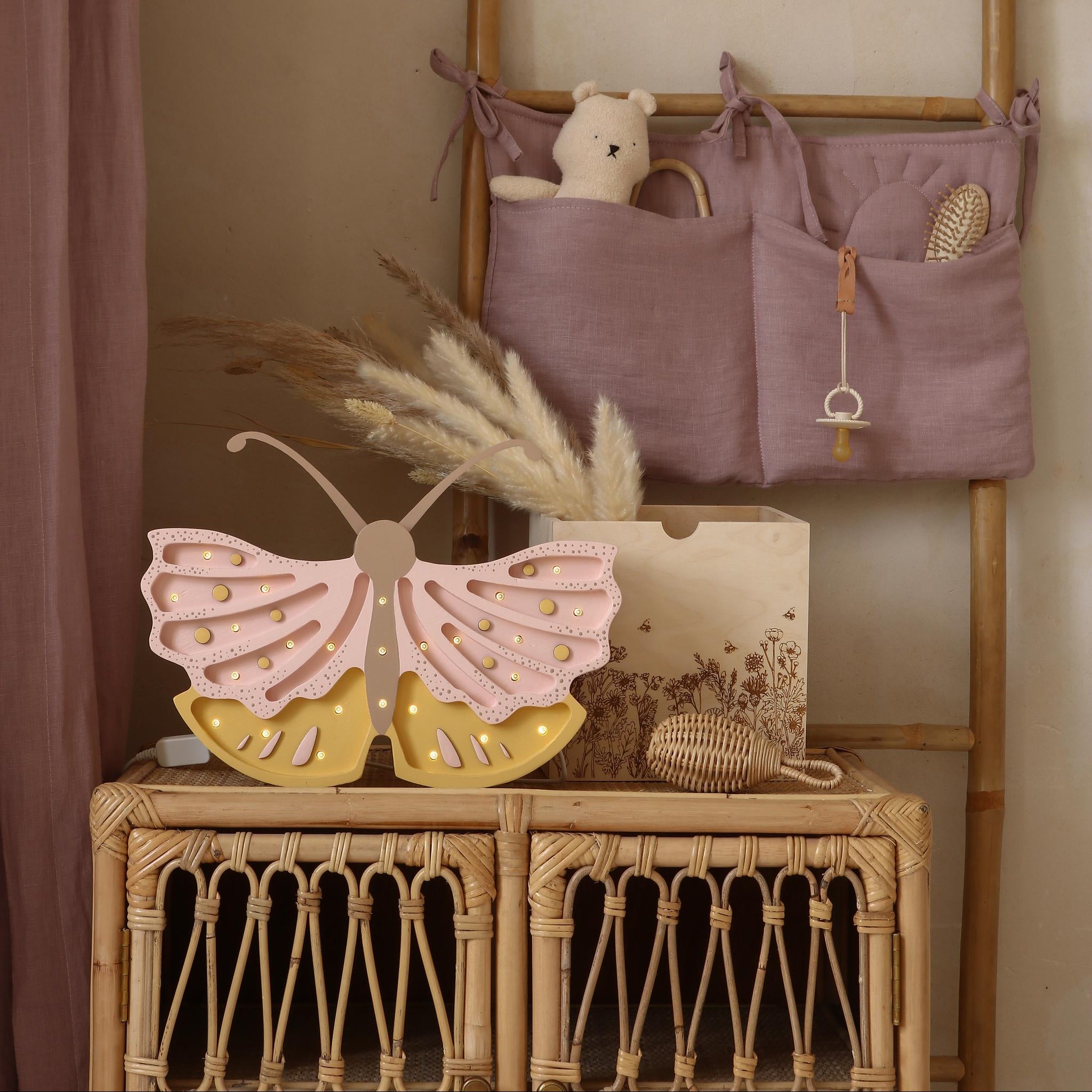 Little Lights butterfly lamp on a wicker cabinet in a baby nursery