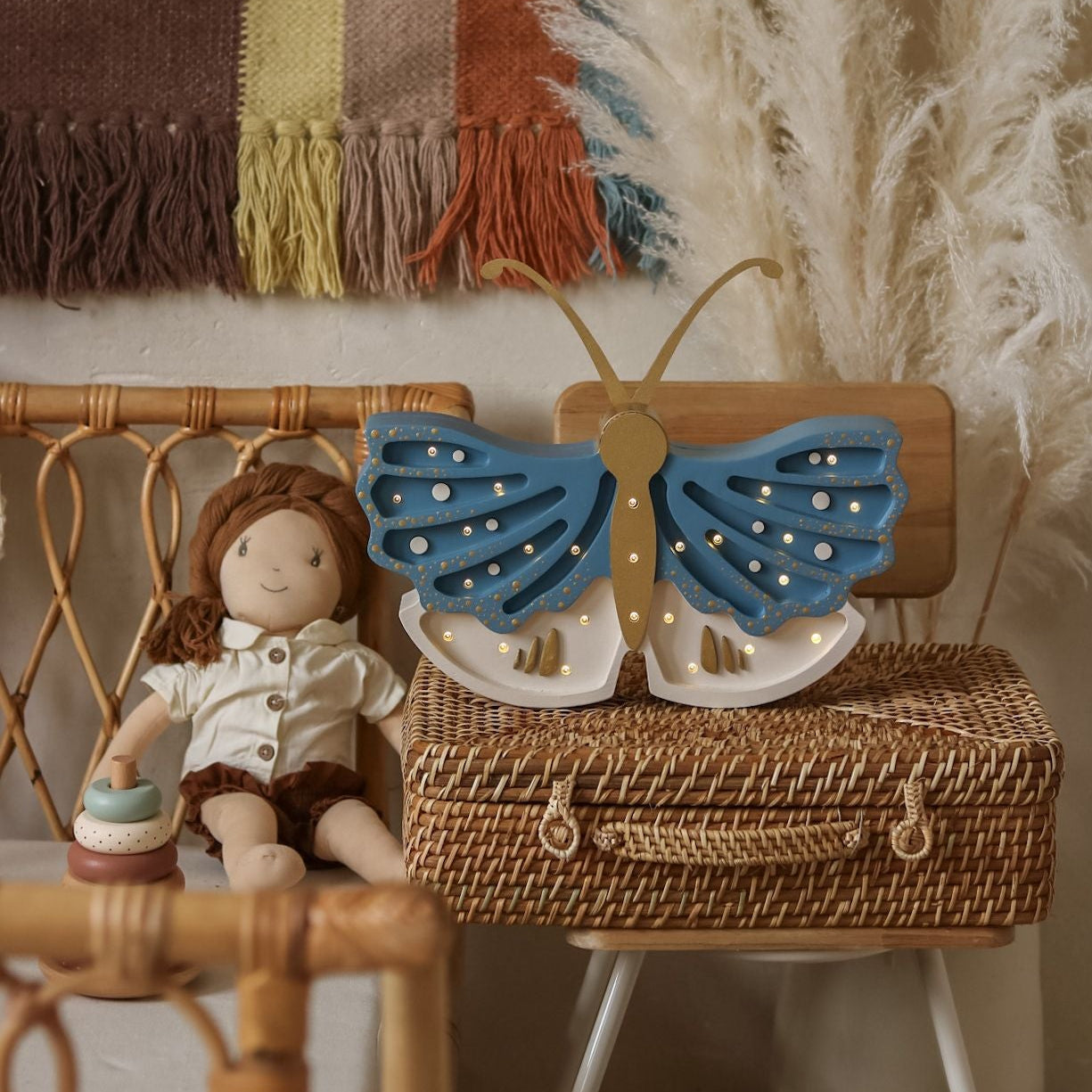 Little Lights Butterfly blue Lamp next to a child's bed