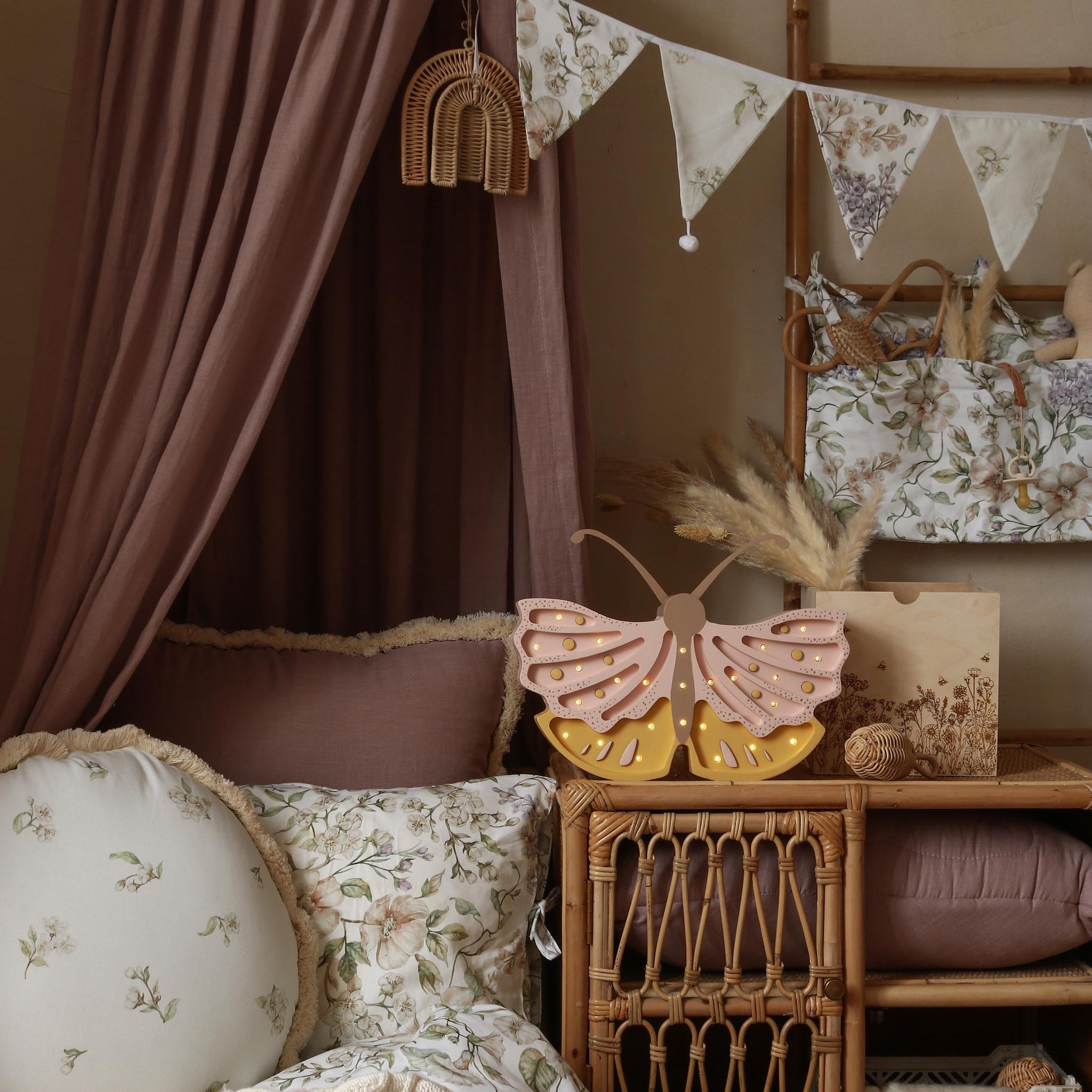 Little Lights Butterfly Lamp in a girl's room with canopy, wicker furniture, and floral elements.