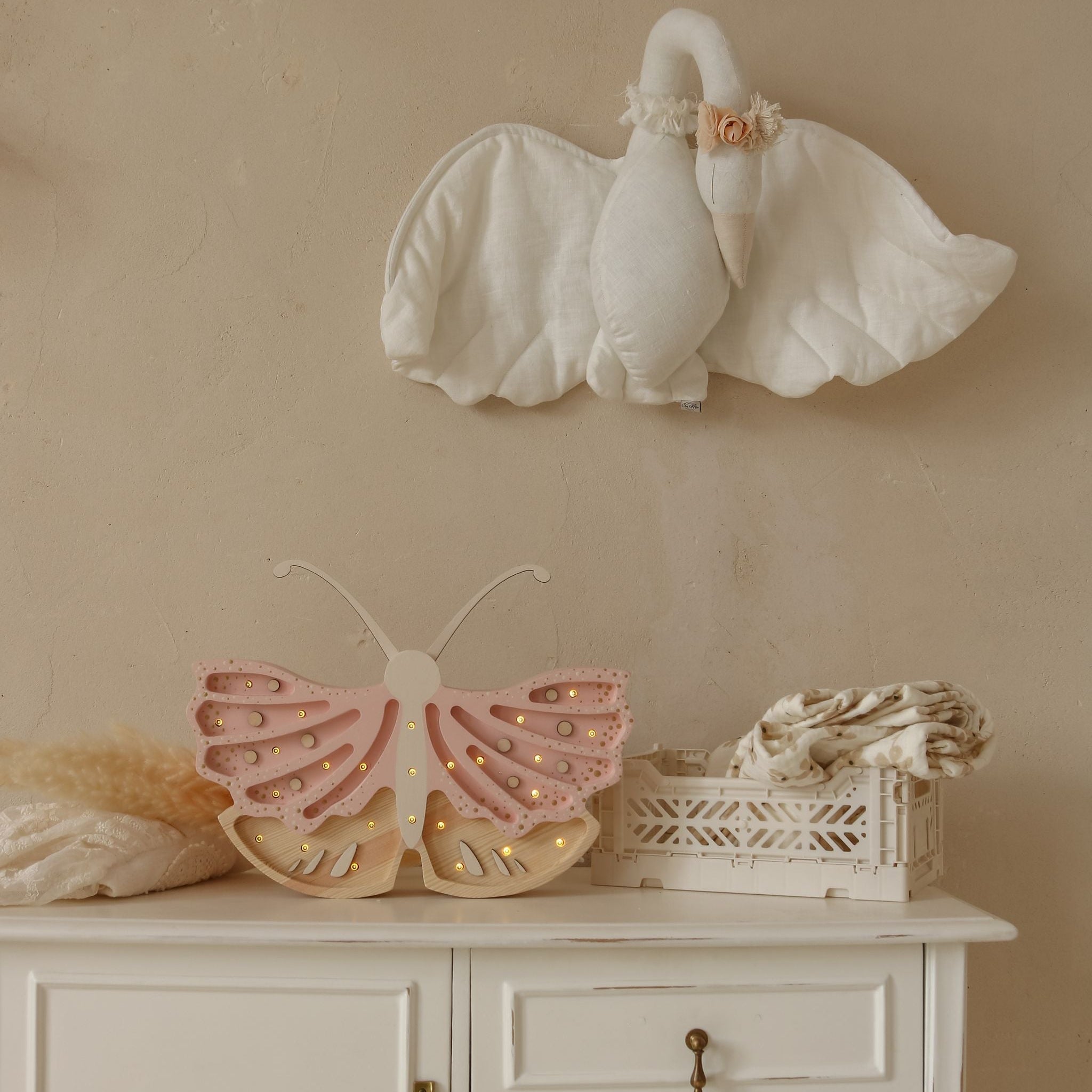 Little Lights pink Butterfly Night Light on a dresser in a baby girl room