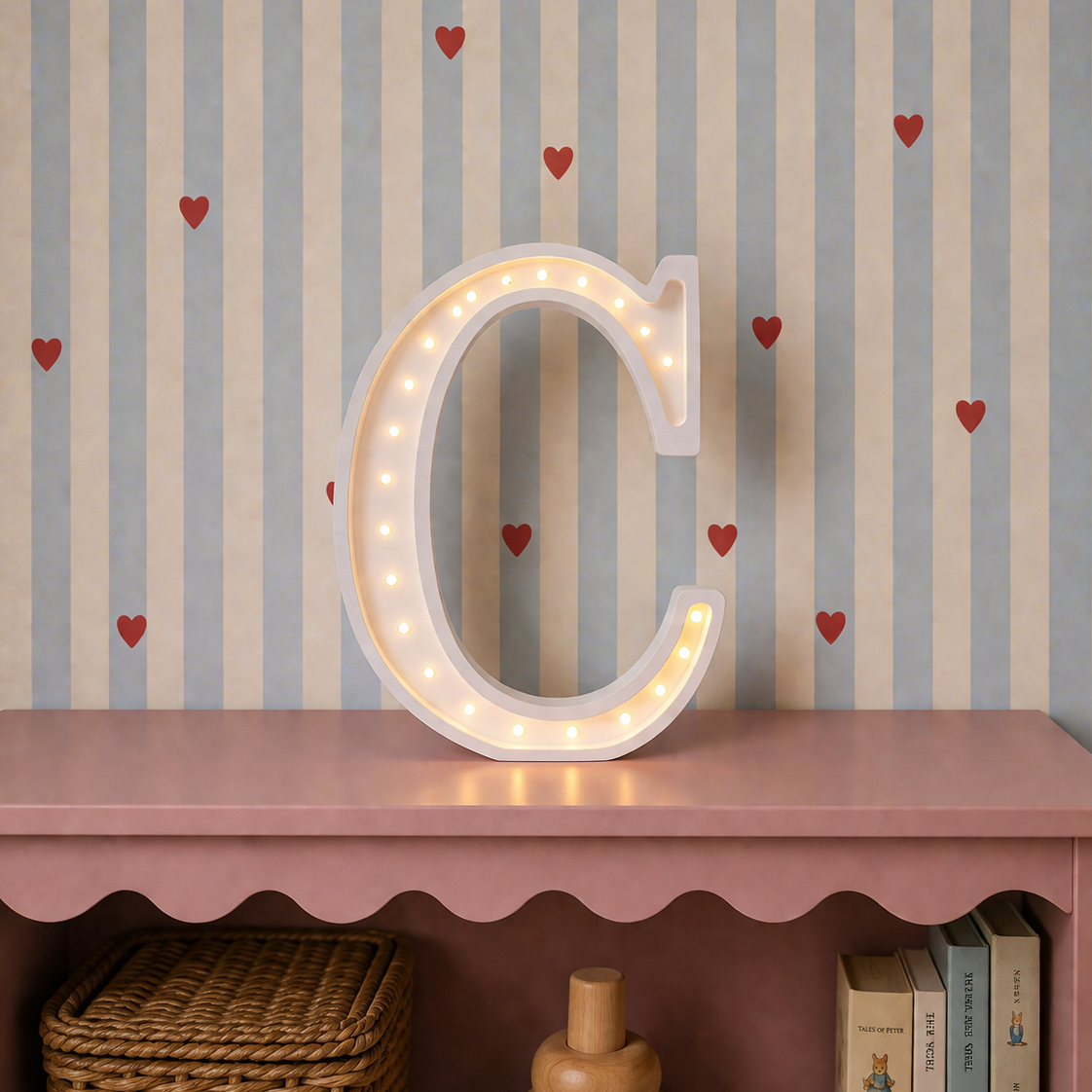 Little Lights white C Letter lamp on a dresser in a baby girl's room