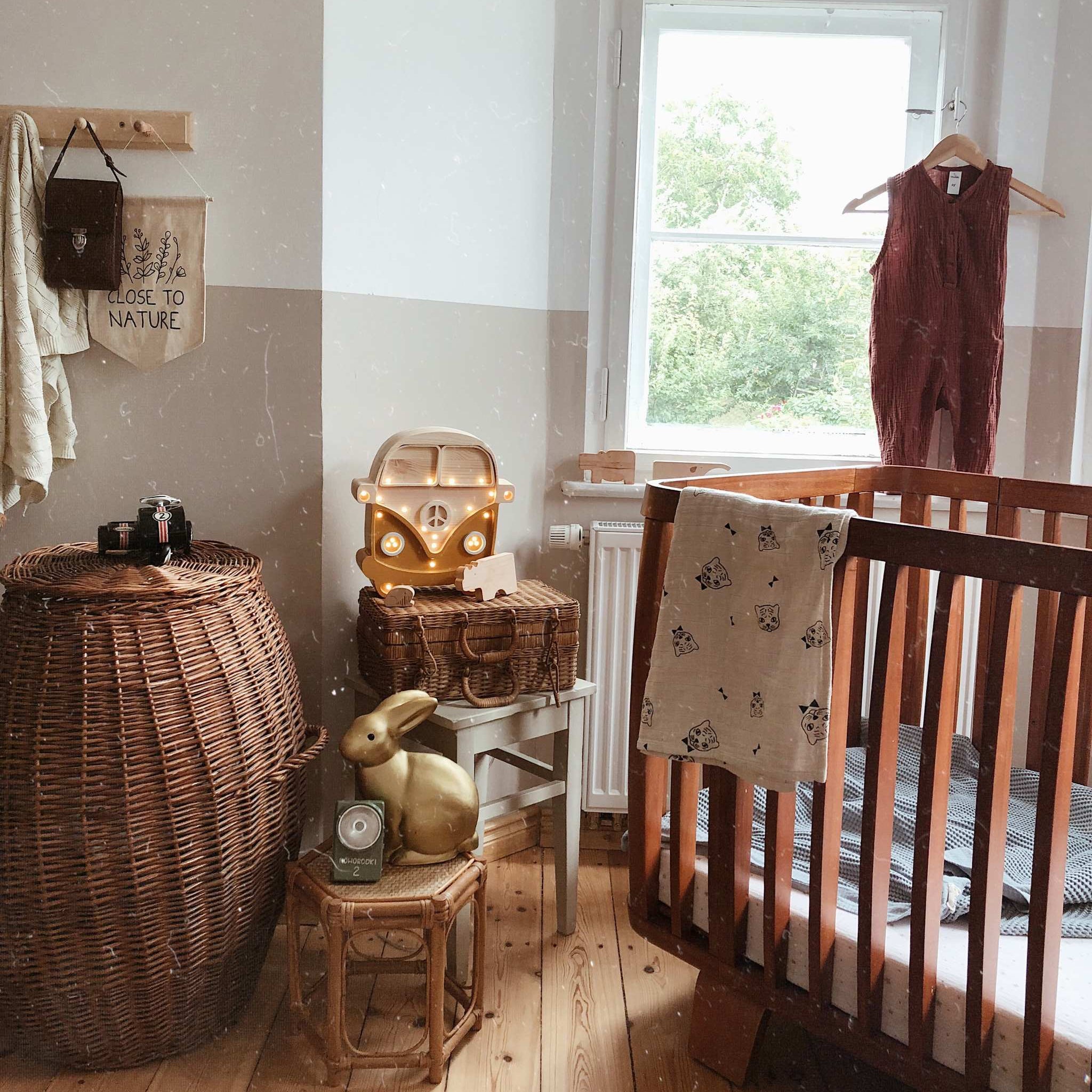 Little Lights Camper Van Lamp Mustard Wood on wicker suitcase in a boy's nursery