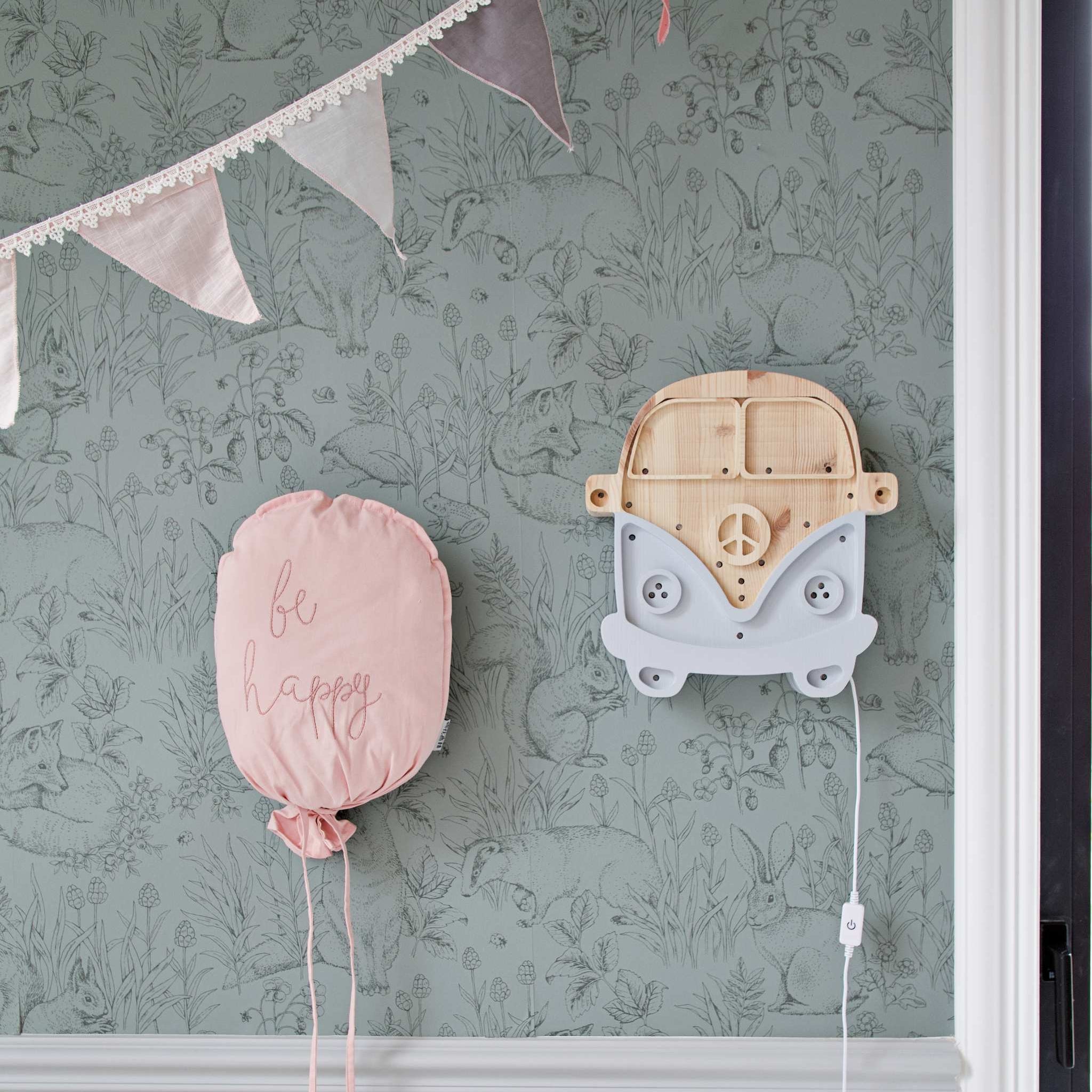 Little Lights Camper Van Night Light hanging on the wall in a girl's nursery