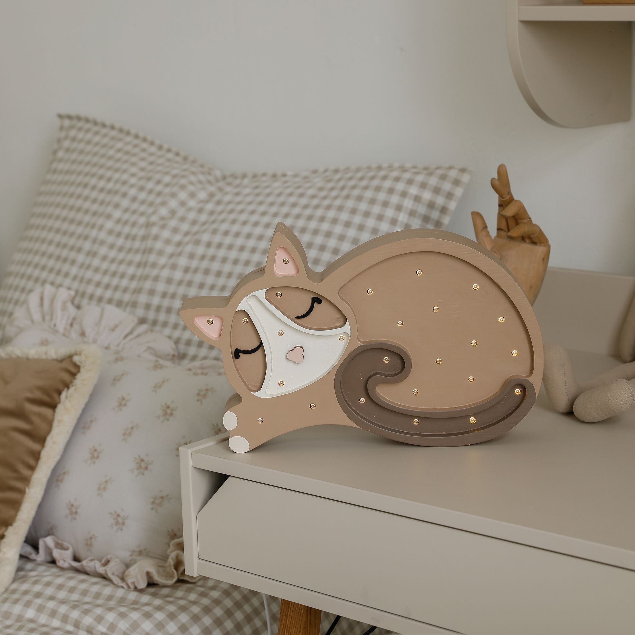 Little Lights Cat Night Light Cappuccino on a desk in a boy's room