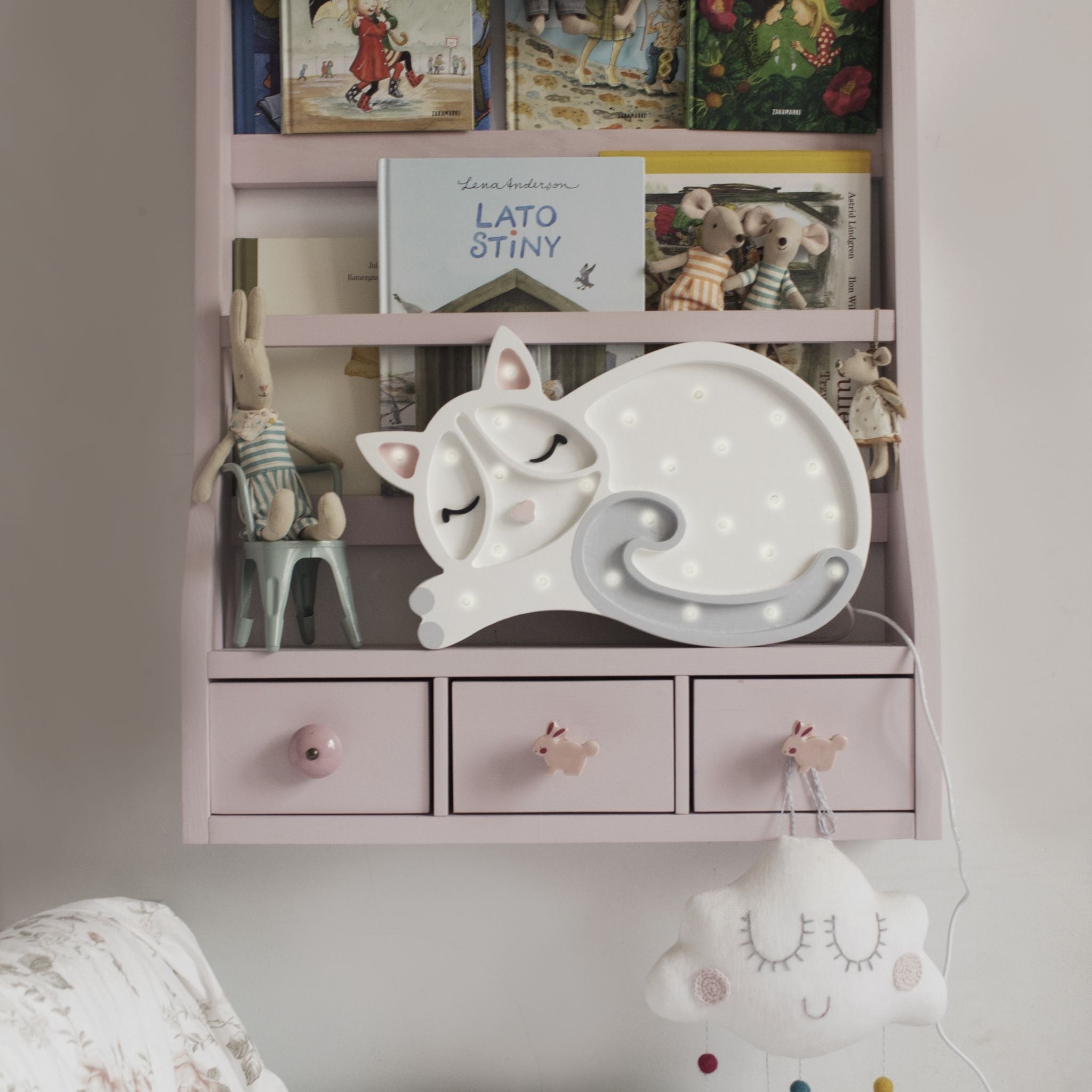 Little Lights Cat Lamp white on a book shelf in a girl's room