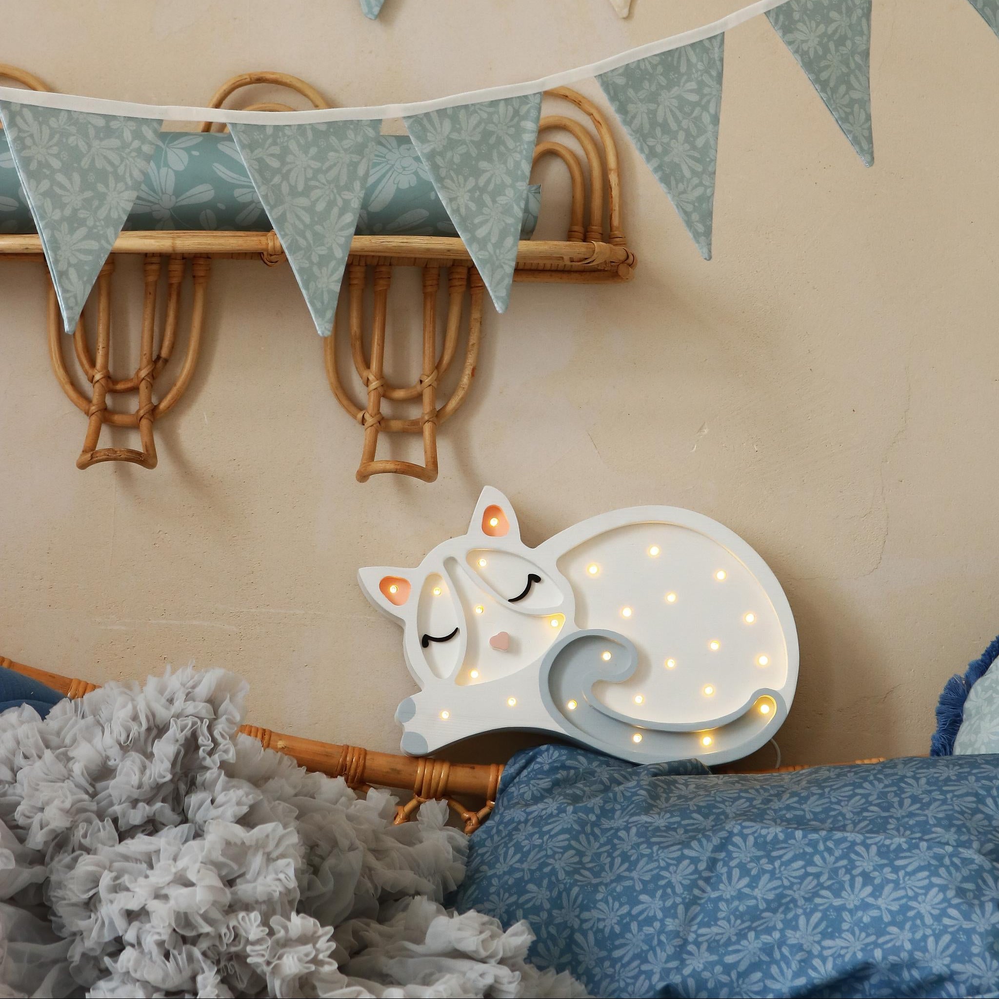 Little Lights Cat Lamp white glowing in a child's room with blue decoration