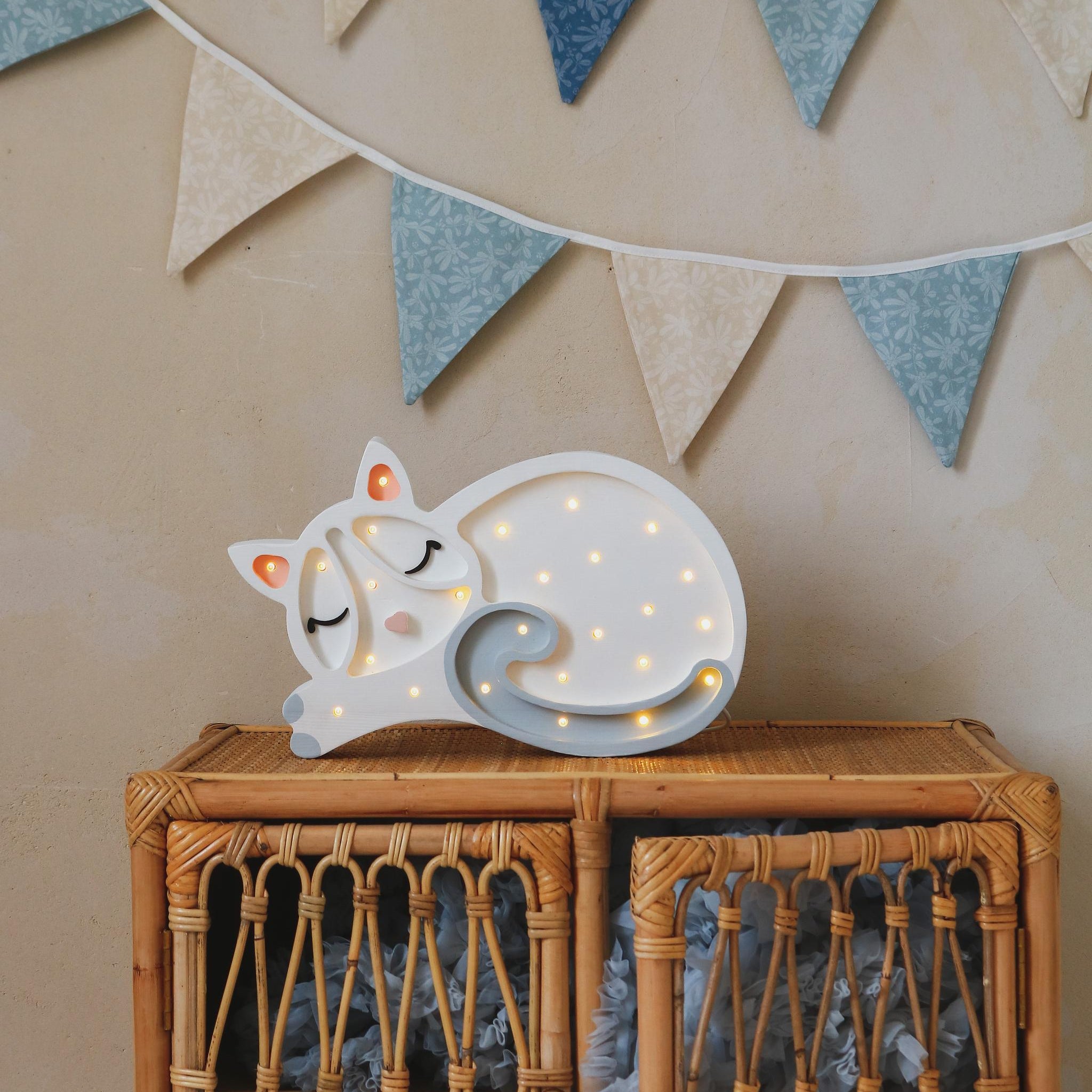 Little Lights Cat lamp white on a wicker dresser in a kid's room