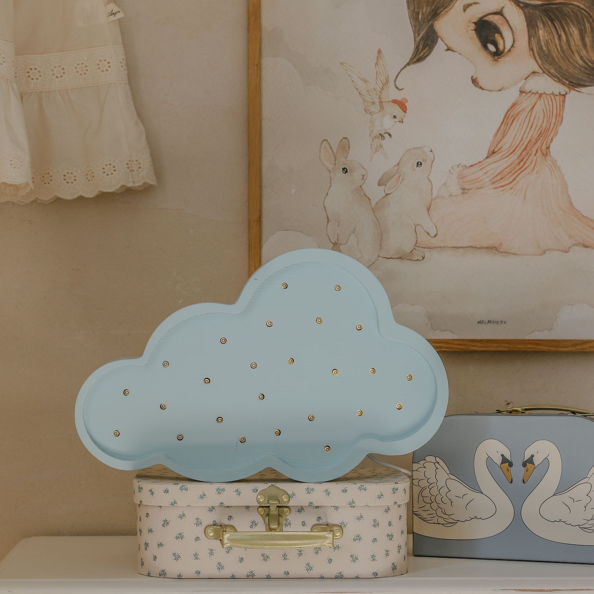 Little Lights Cloud Lamp Blue on a dresser in a girl's nursery