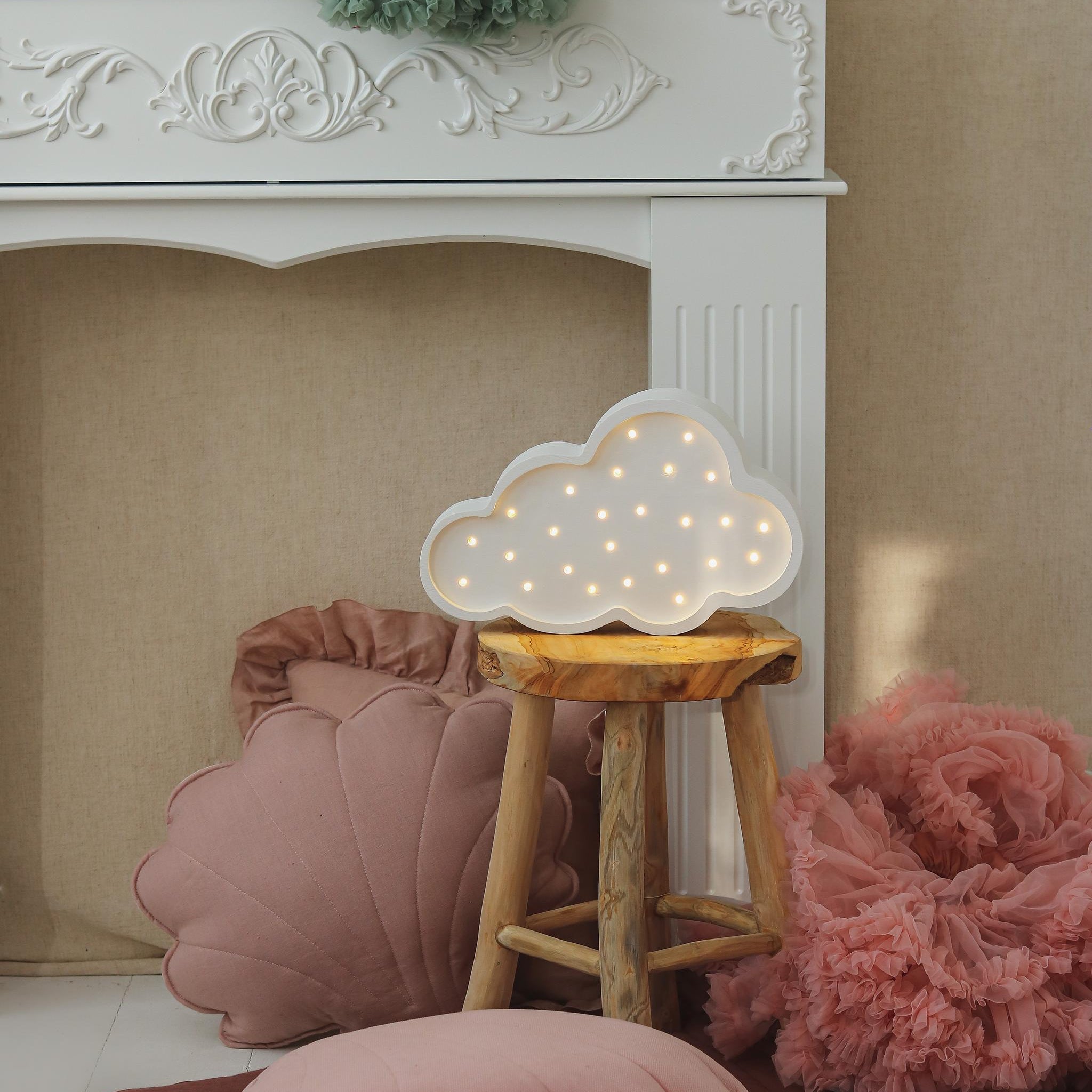Little Lights Cloud Lamp on a kid's room next to soft pillows