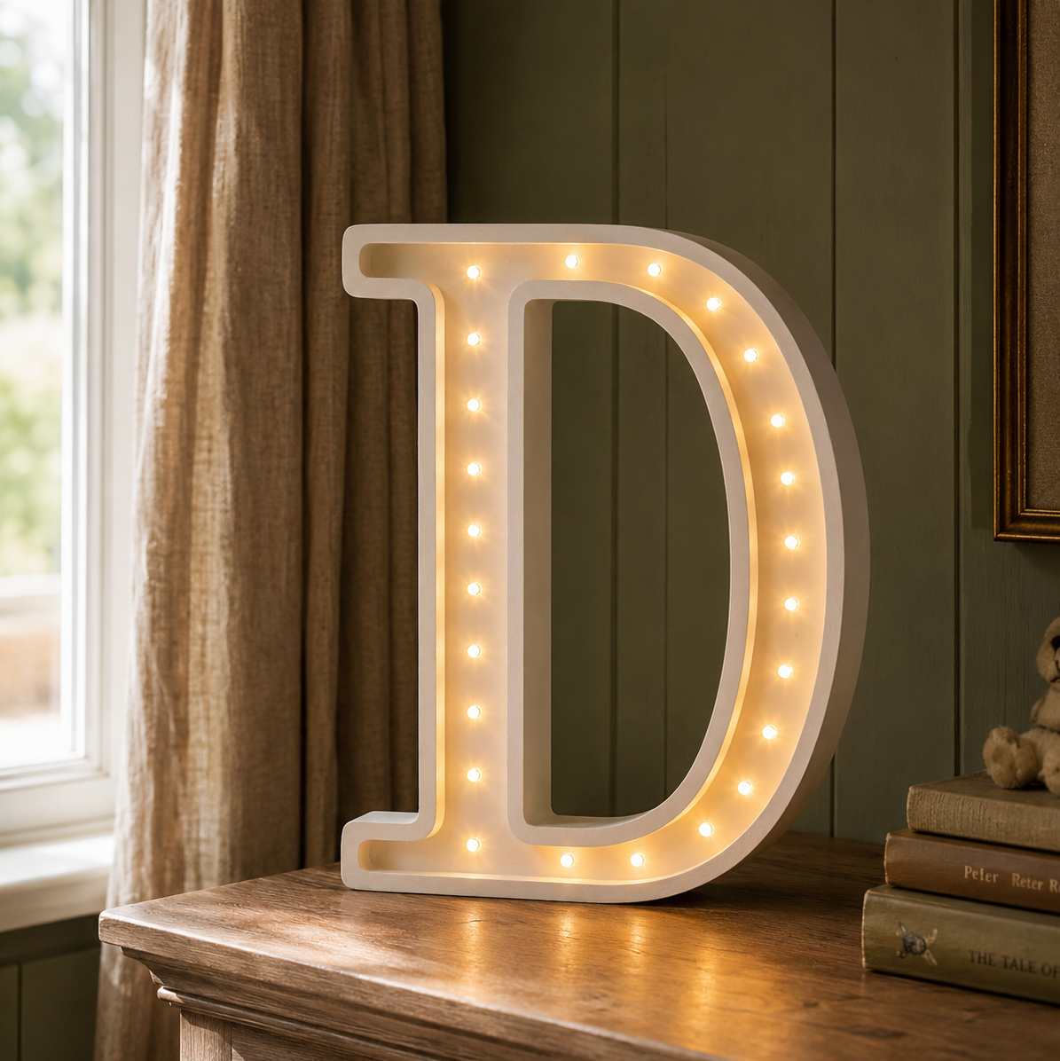 Little Lights D Letter Night Light glowing on a dresser in a baby nursery