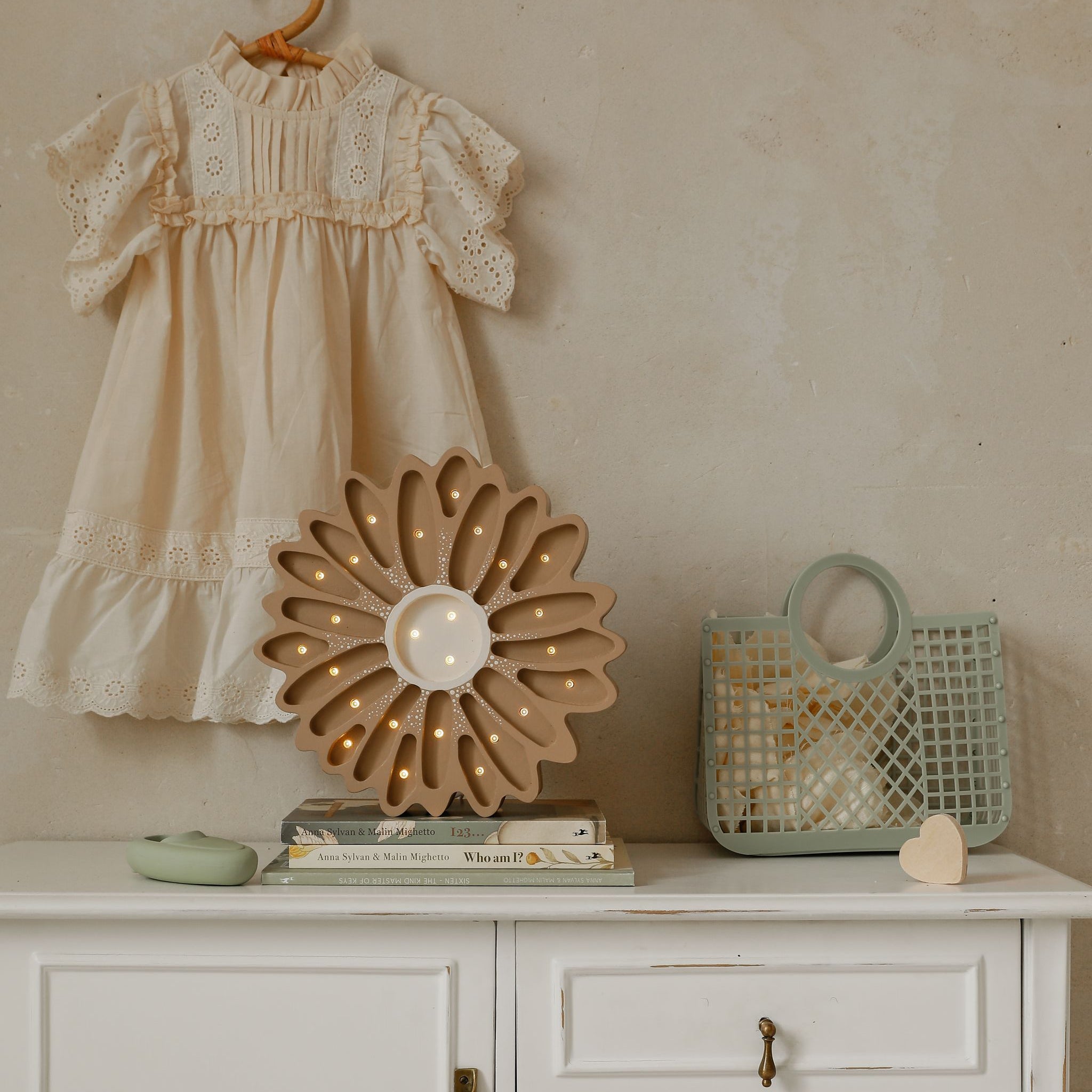 Little Lights Daisy Flower Lamp brown on a dresser in a baby girl room