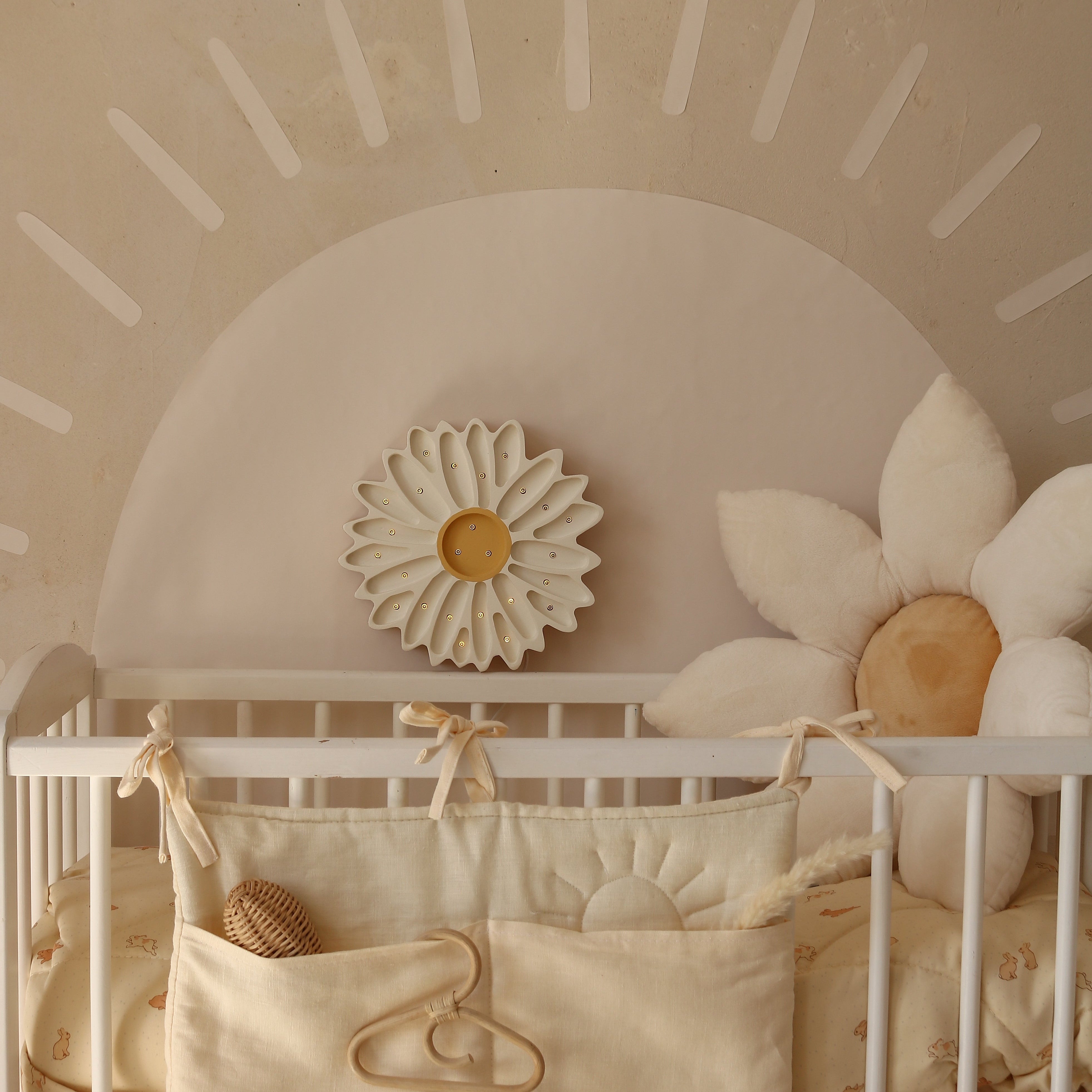 Little Lights Daisy Lamp white next to a baby crib