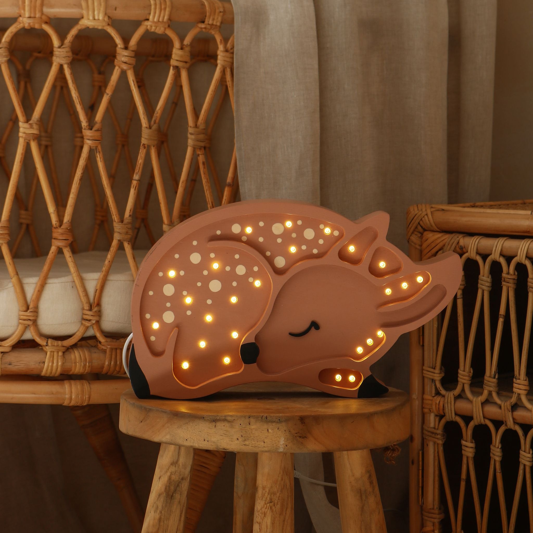 Little Lights Deer night light glowing softly in. a baby nursery