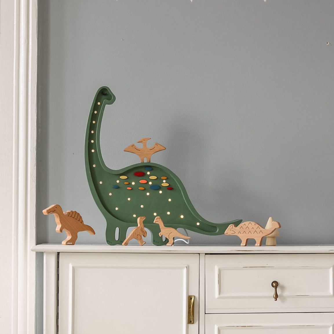 Little Lights Dinosaur Green Diplodocus Lamp on a dresser in a boy's room