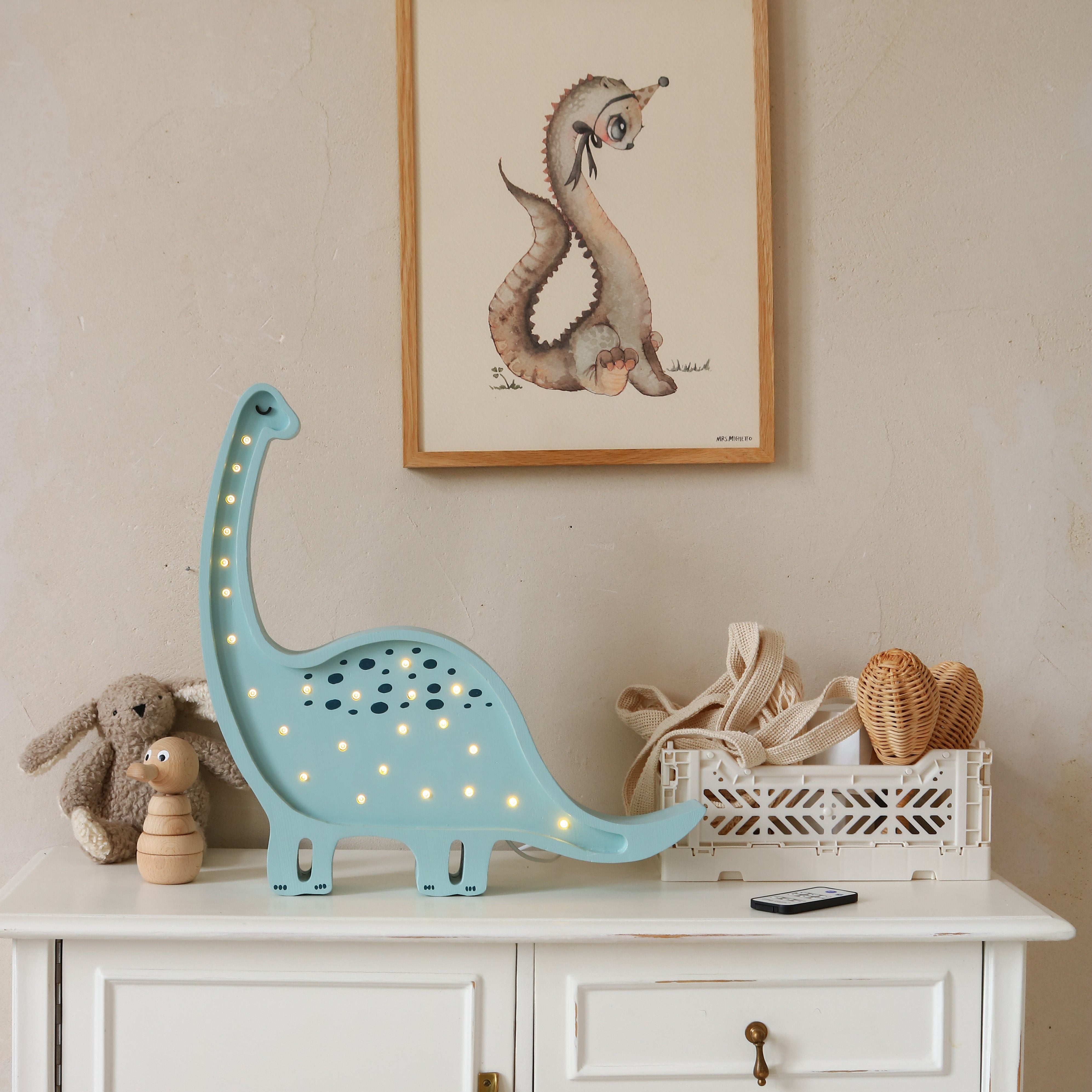 Little Lights Dino Diplodocus lamp on a white dresser in a baby nursery
