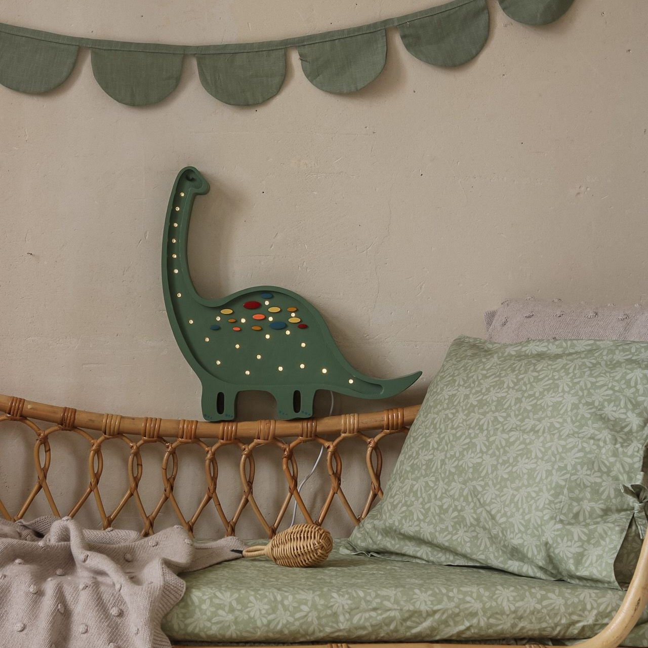 Liittle Light Dino Diplodocus Lamp glowing near kid's bed