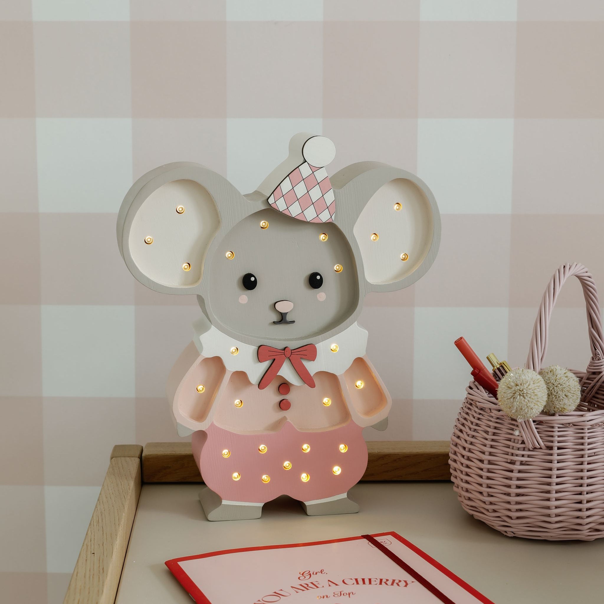 Little Lights Pink Felix the Mouse night light glowing softly on a desk in the girl's room