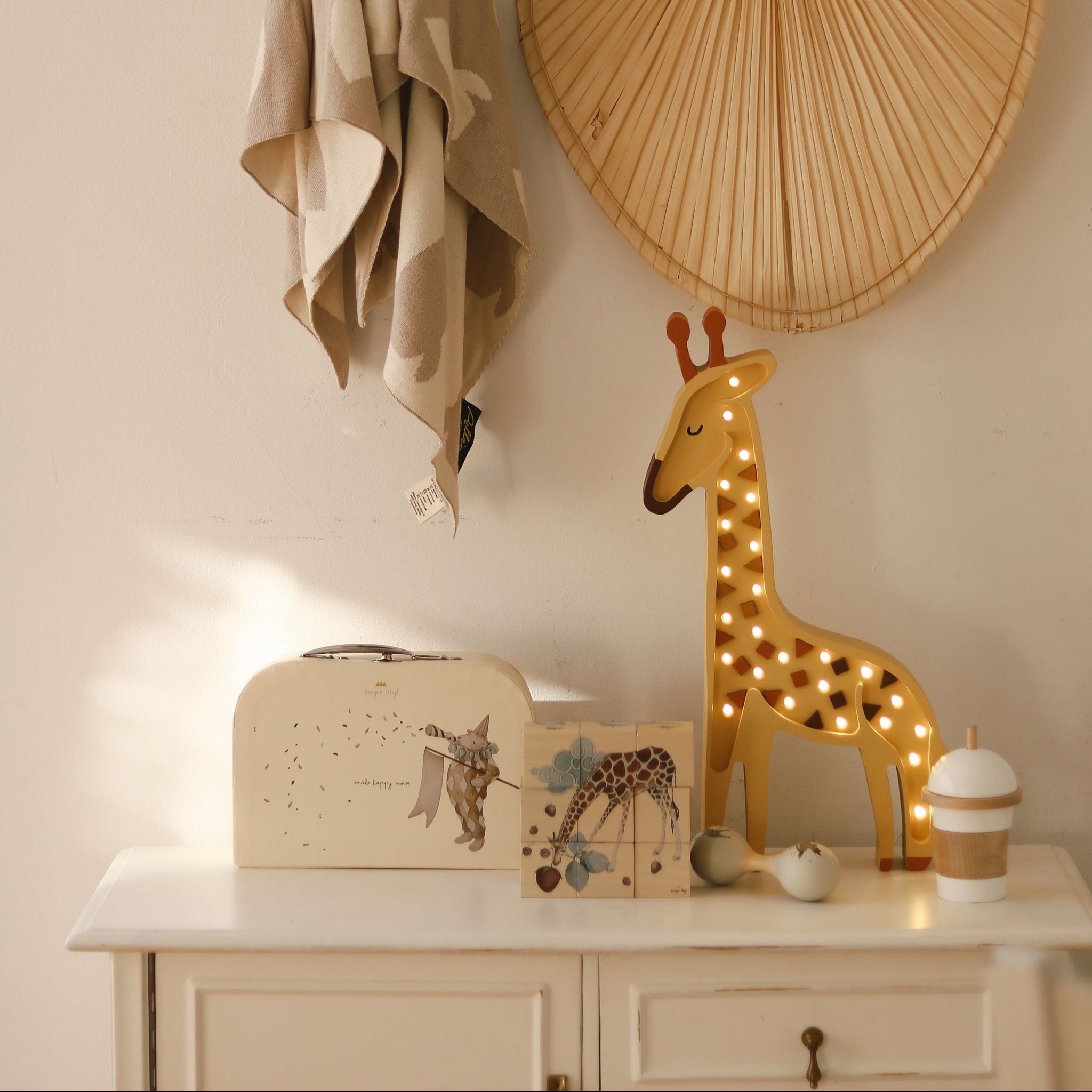 Little Lights yellow Giraffe Night Light glowing softly in a baby nursery room