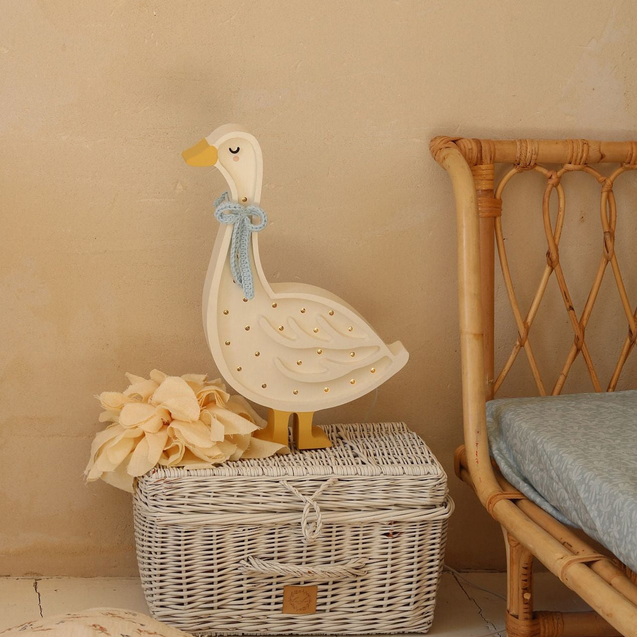 Little Lights Goose Lamp glowing softly by the bed in a kid's room