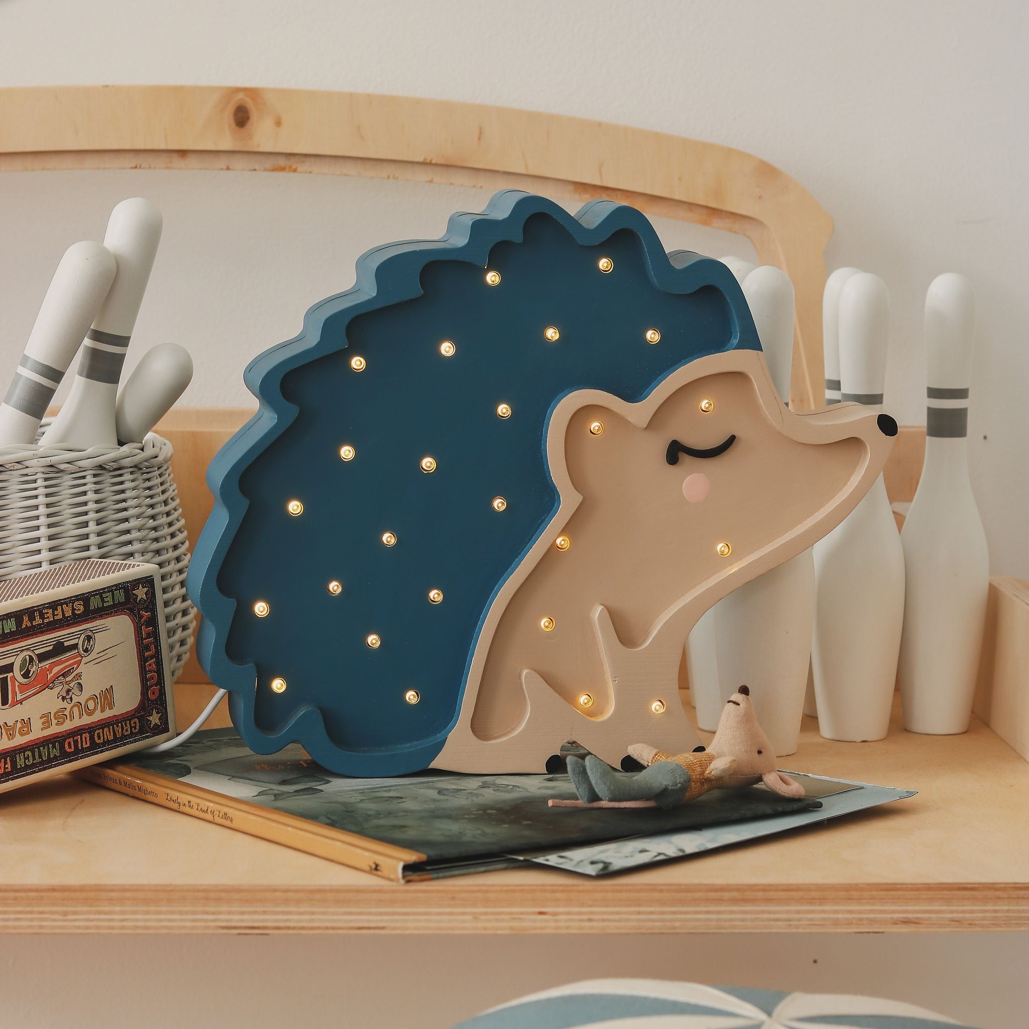 Little Lights blue hedgehog lamp on a desk in a kid's room