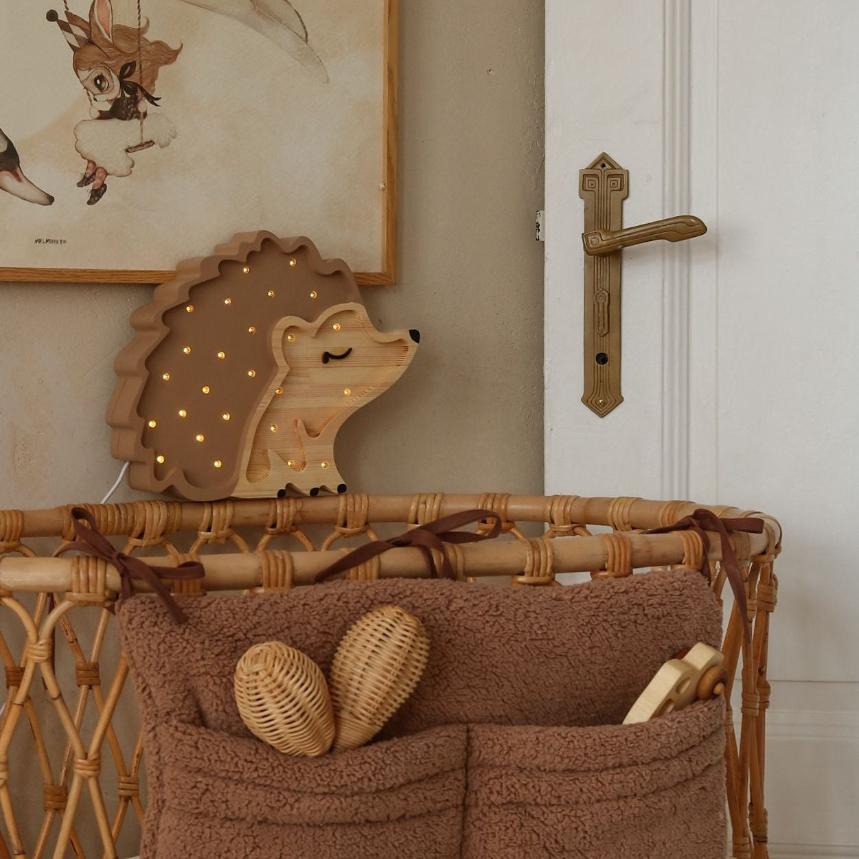 Little Lights brown Hedgehog Night Light by a baby crib in a baby nursery