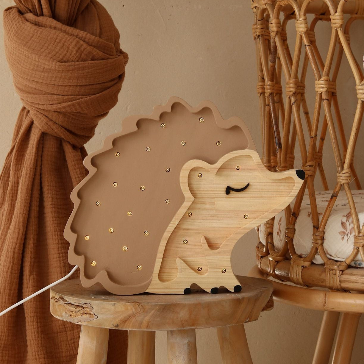 Little Lights brown Hedgehog lamp by the crib in a baby nursery