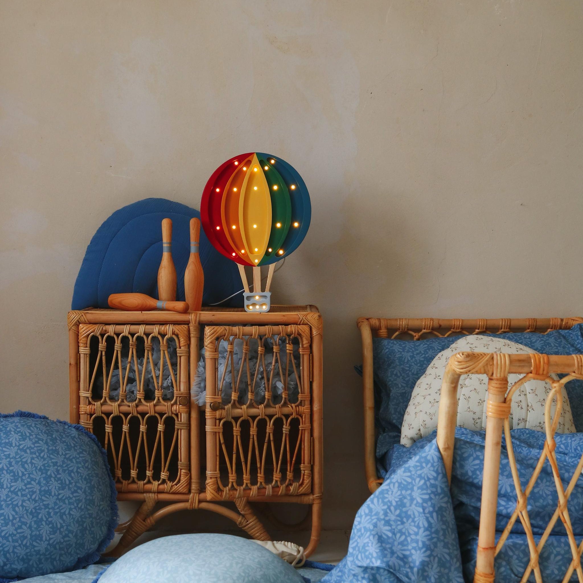 Little Lights How Air Balloon lamp on a dresser by the bed in a kid's room