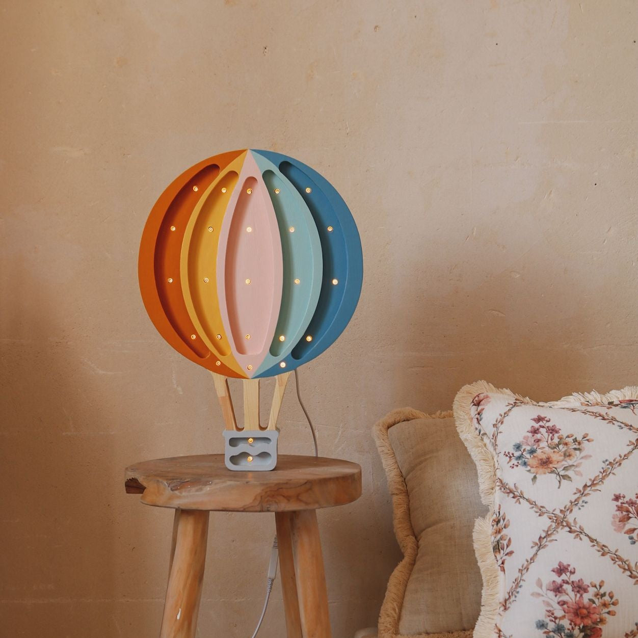 Little Lights Hot Air Balloon retro rainbow by the bed in a girl's room