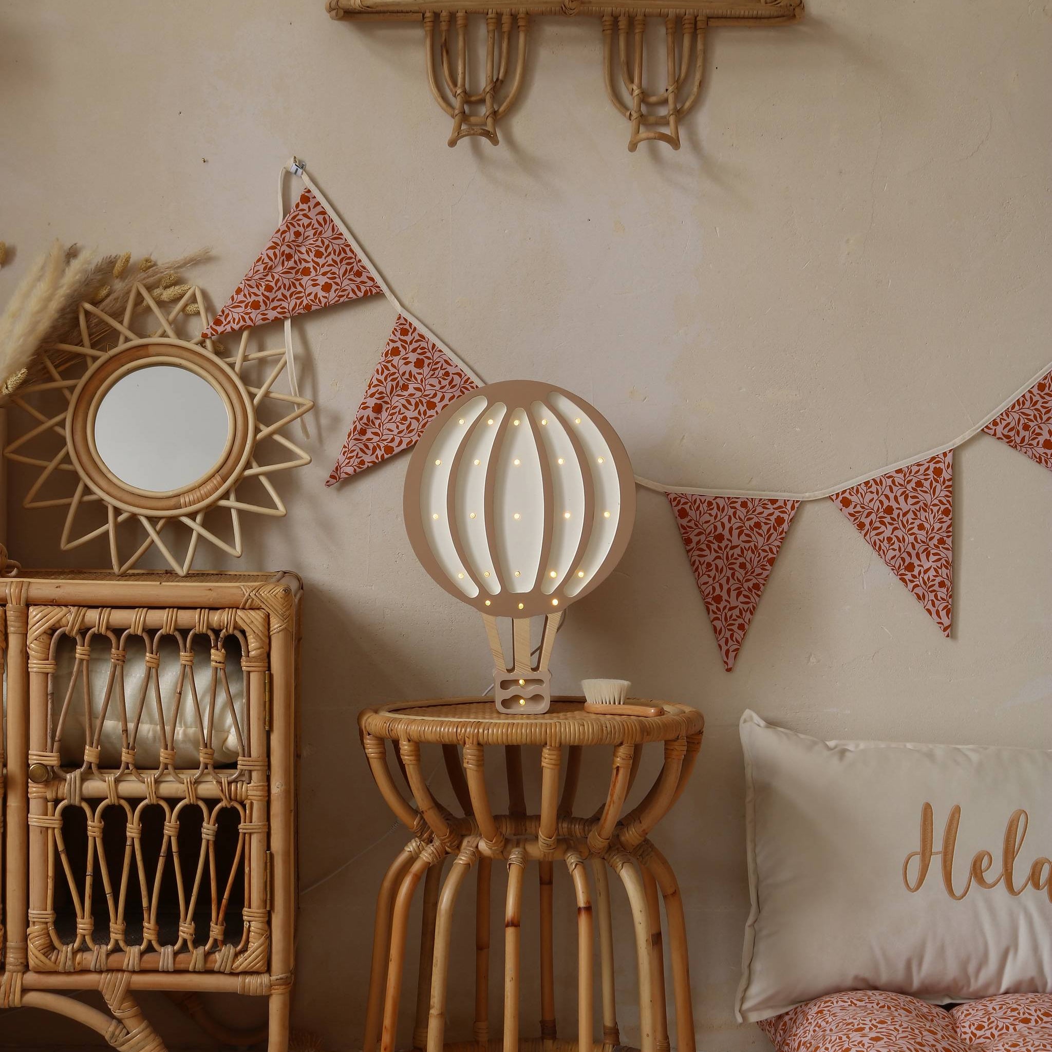 Little Lights Hot Air Balloon wooden brown night light on a table in a girl's room