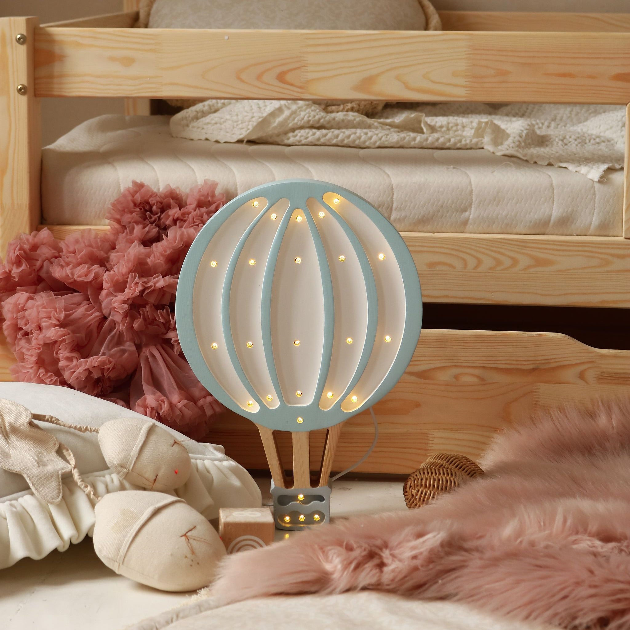 Little Lights Hot Air Balloon blue night light in a girl's room by bed