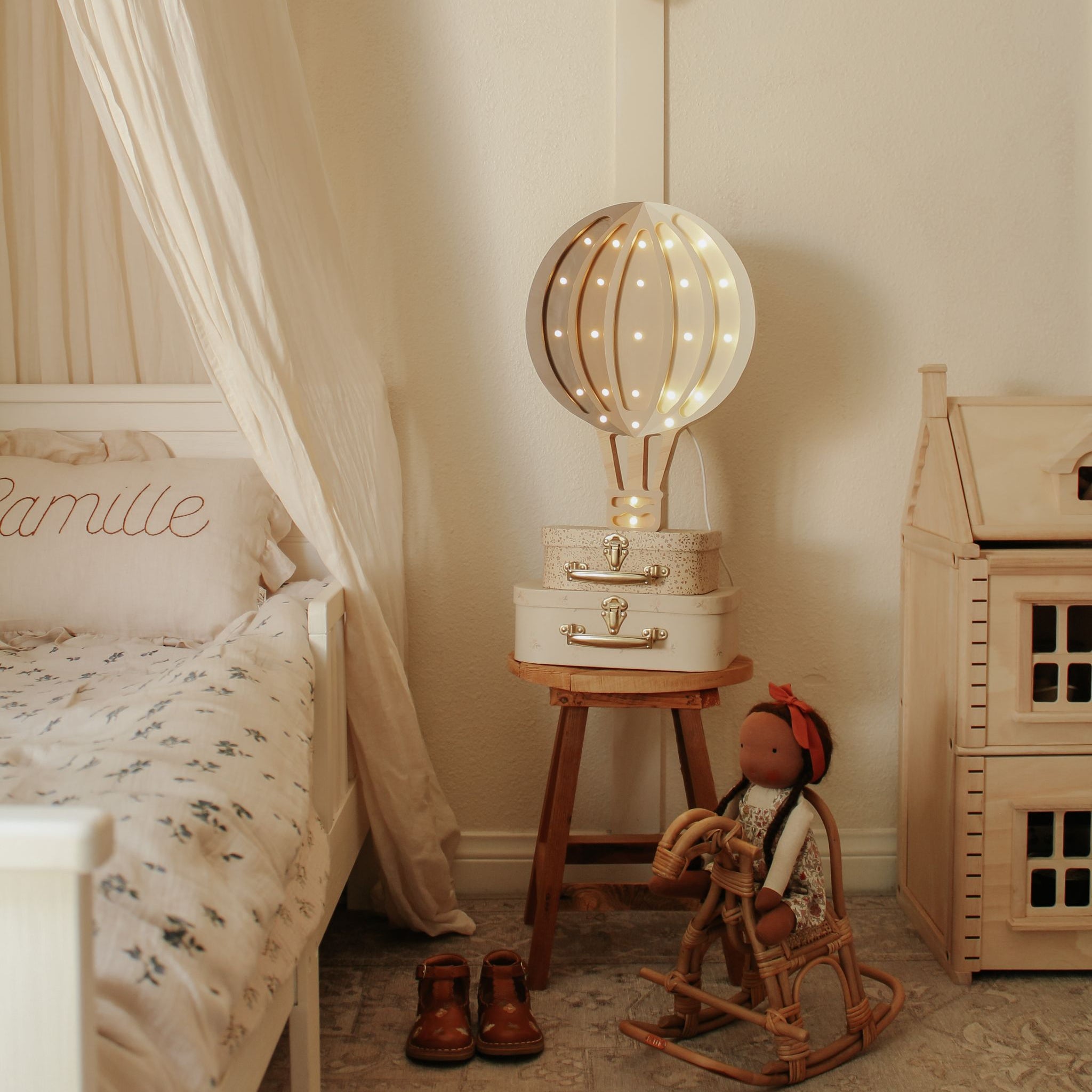 Little Lights Hot Air Balloon brown and cream Night Light by a bed in a girl's room