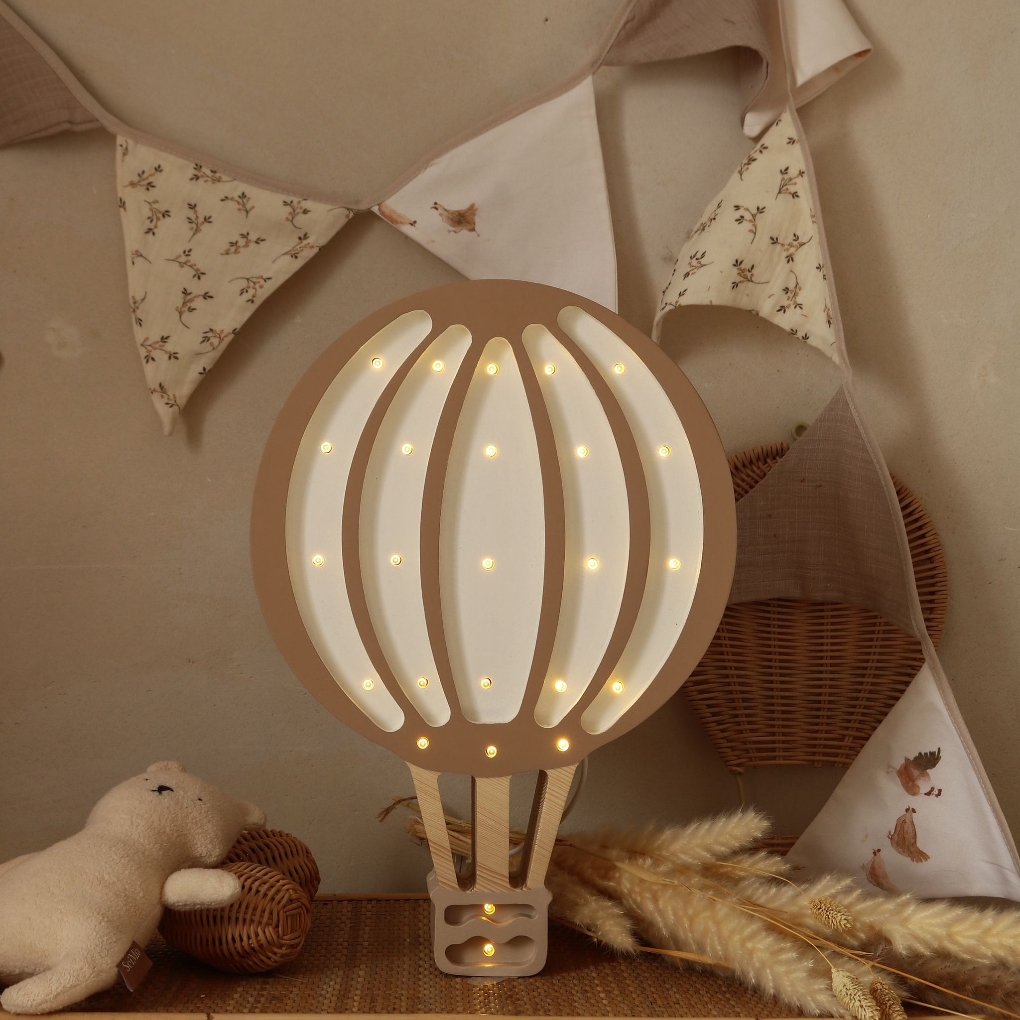 Little Lights Hot Air Balloon brown night light on a dresser in a baby nursery