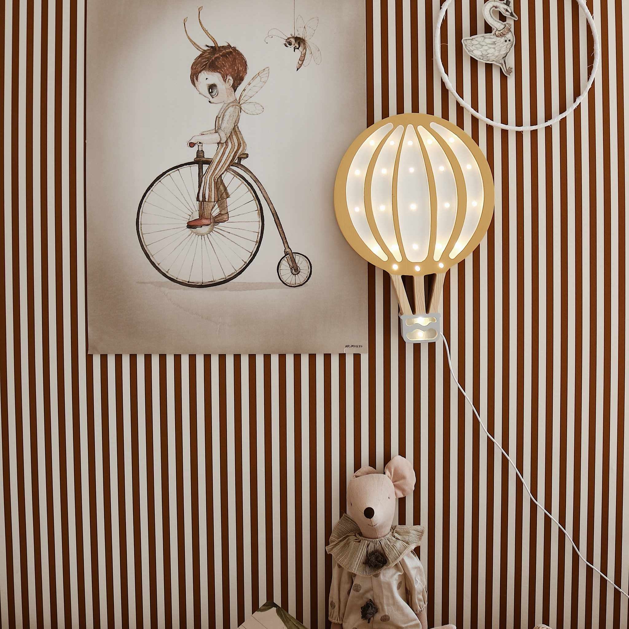 Little Lights Hot Air Balloon mustard hung on the wall in a kid's room