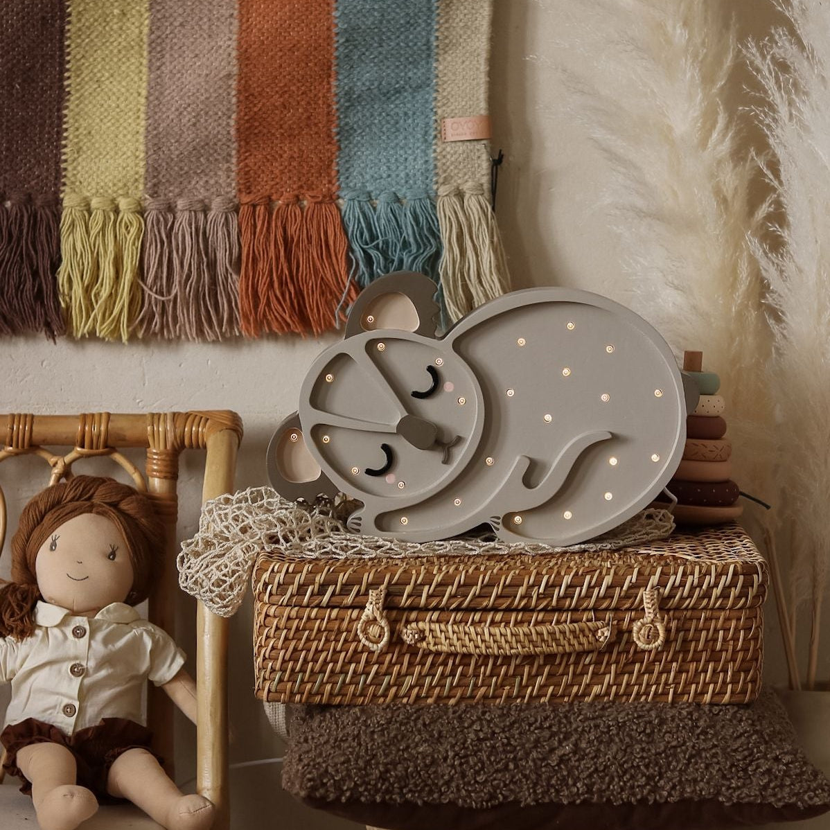 Little Lights grey Koala Bear Lamp in a kid's room be the bed