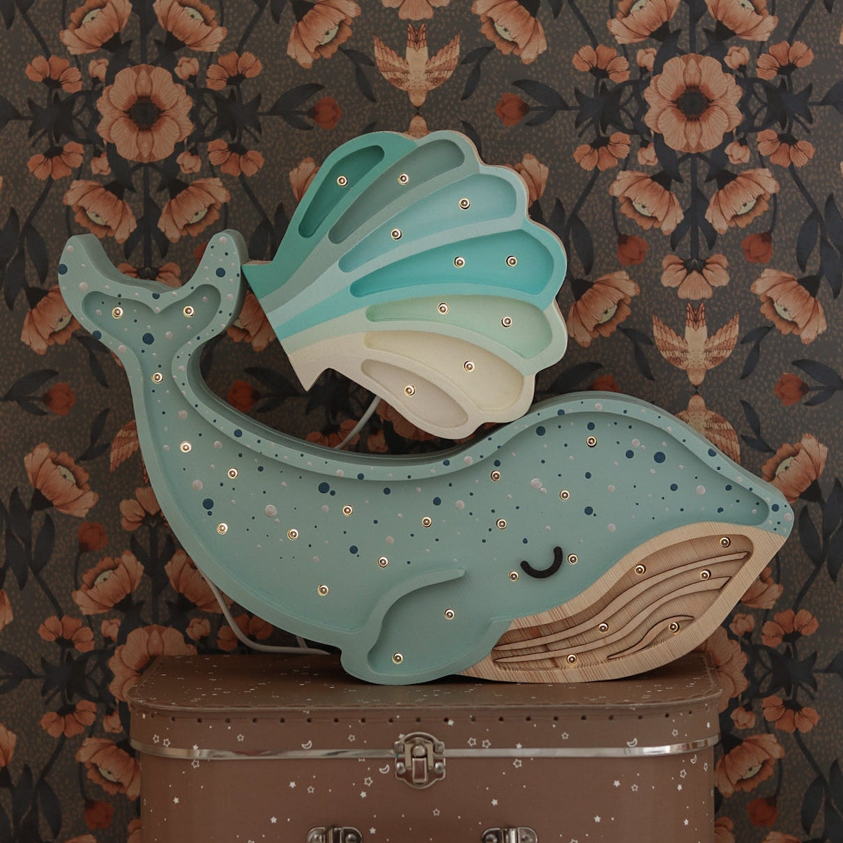 Light Blue Whale Lamp paired with a blue Seashell Lamp against a darker floral wallpaper