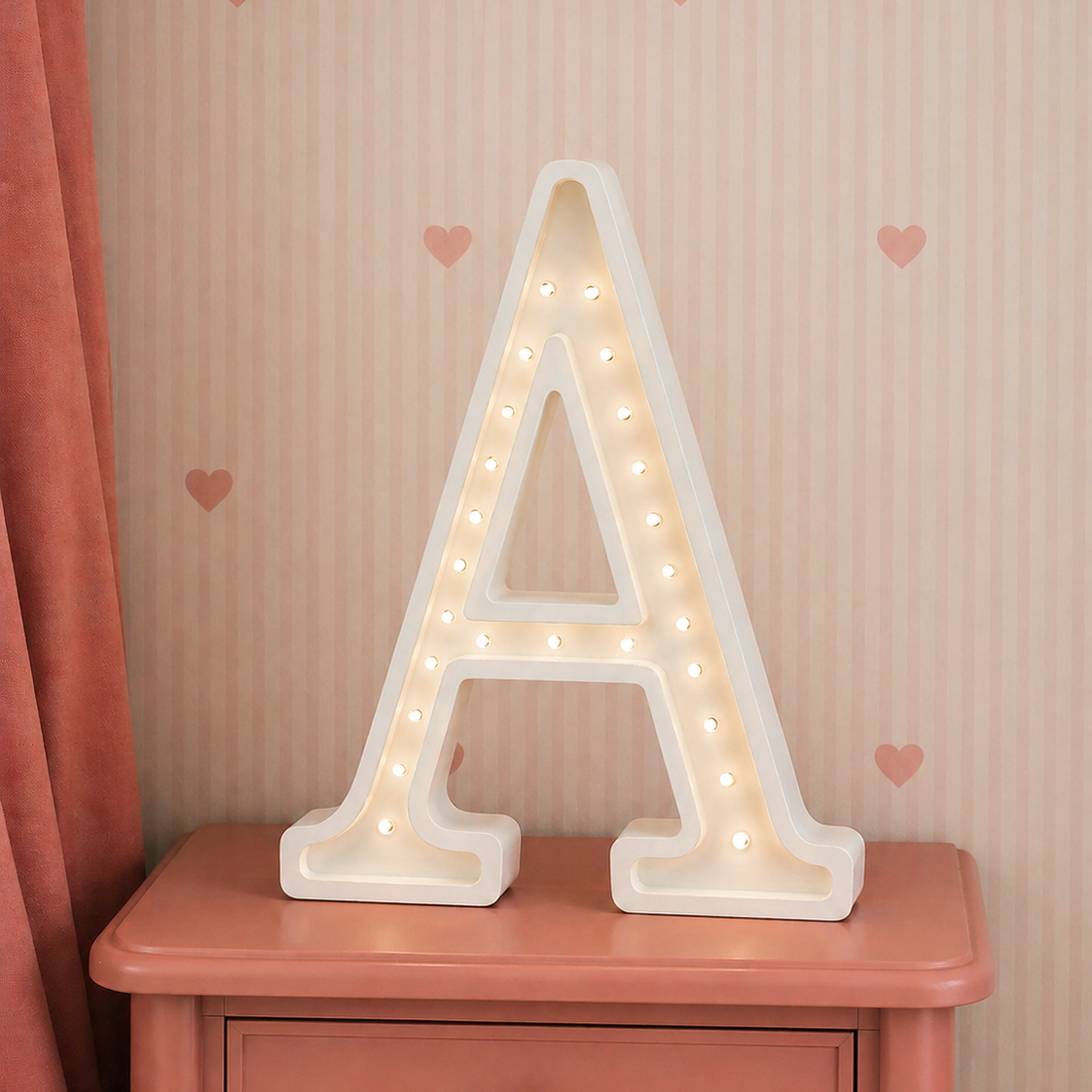 Little Lights A Letter LED Lamp glowing in a girl's room on a night stand