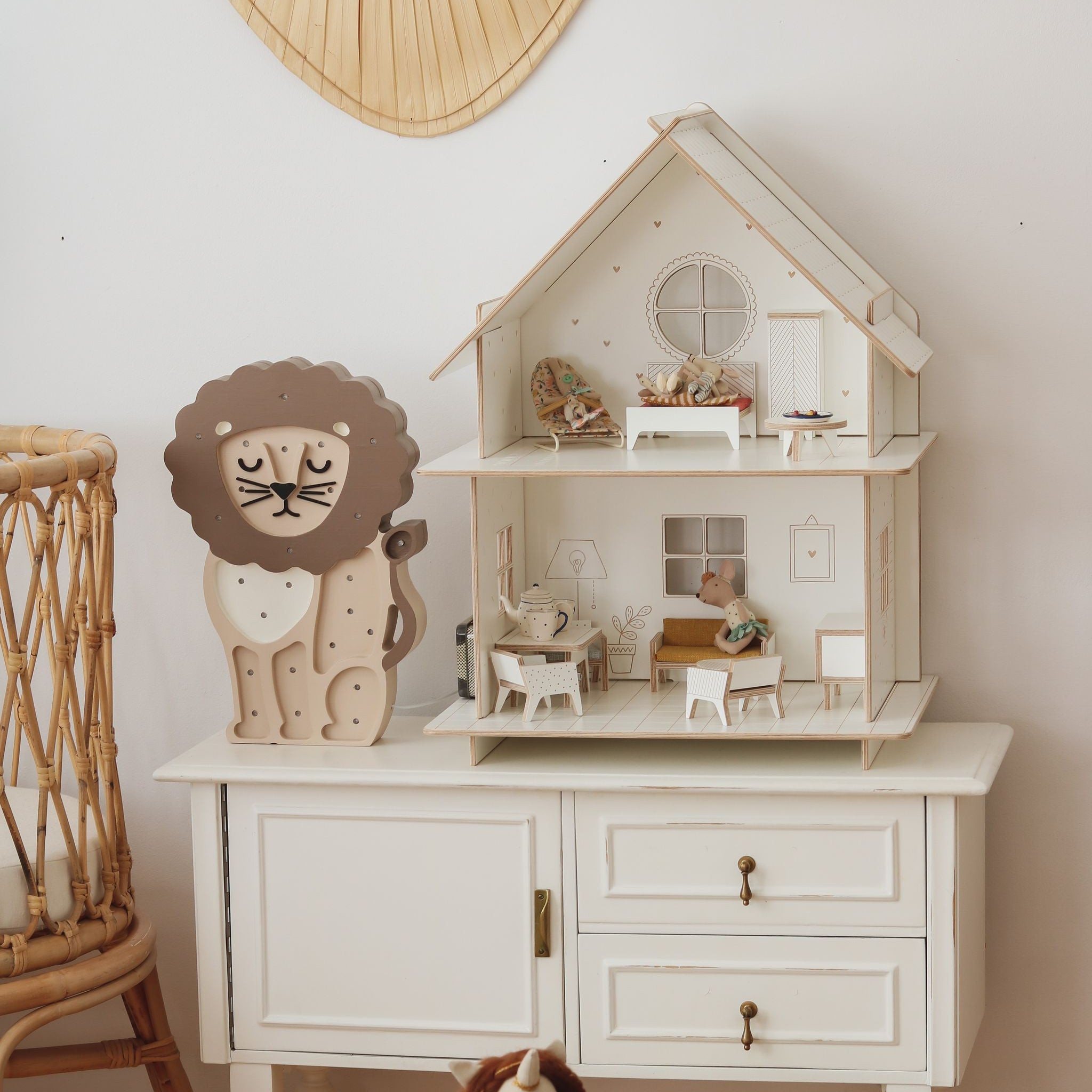 Little Lights beige Lion Night Light in a girl's room next to a crib