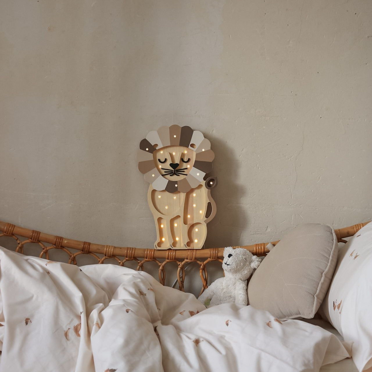 Little Lights wooden night light glowing softly by the bed in a kiid's room