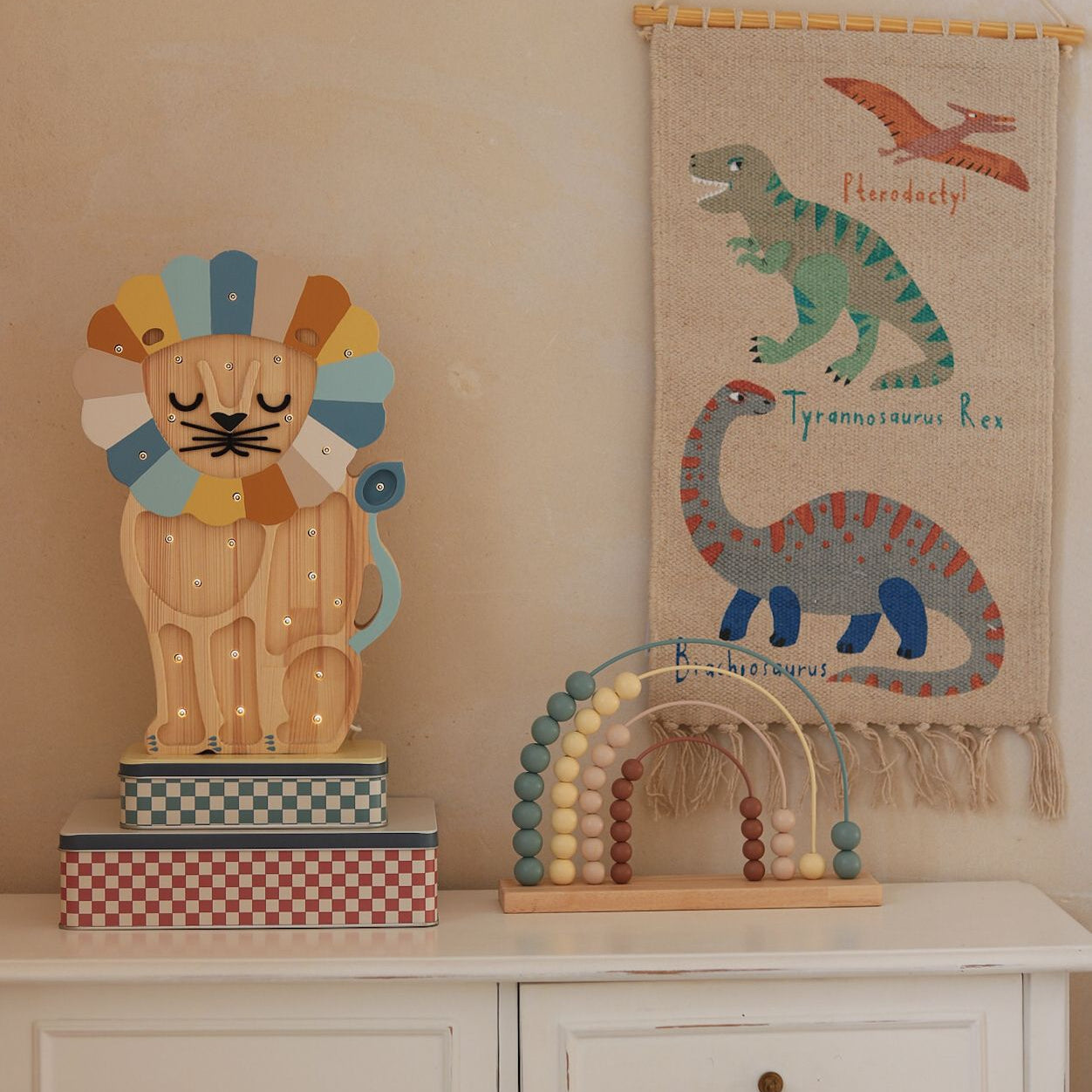 Little Lights denim rainbow wooden Lion night light on a dresser in a baby boy nursery