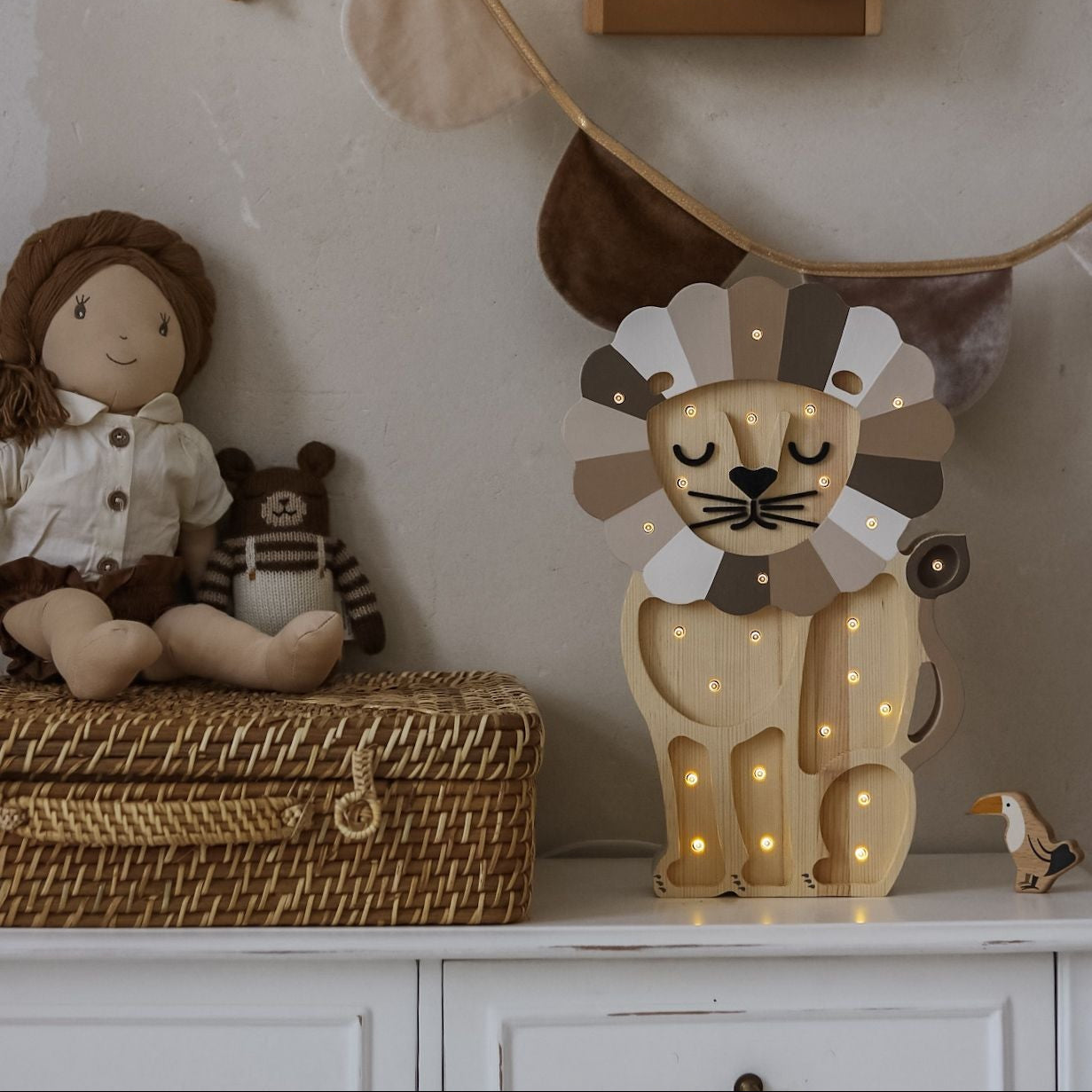 Little Lights wooden Lion night light with beige mane in a kids room on a dresser