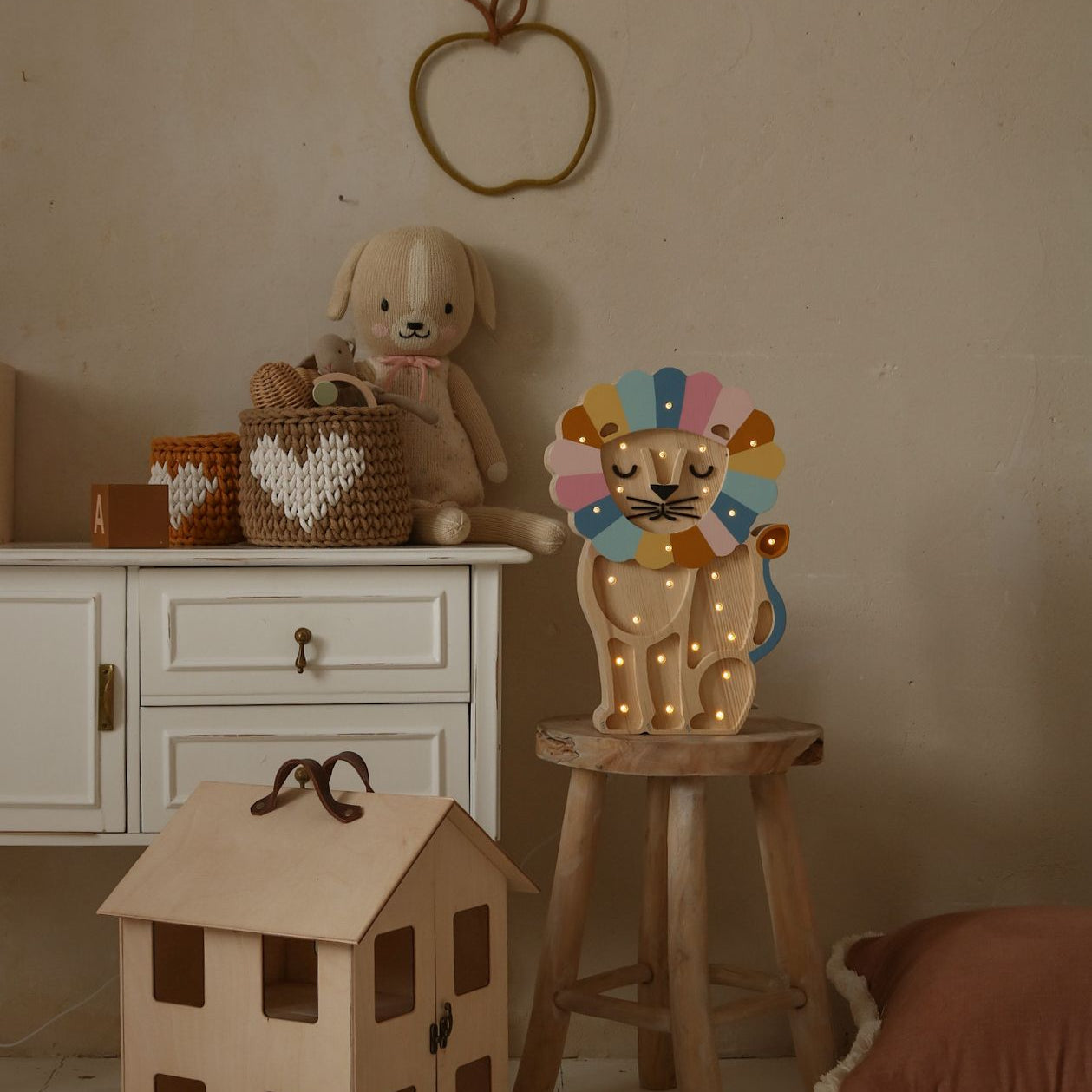 Little light colorful wooden Lion Lamp on a stool in a kid's room