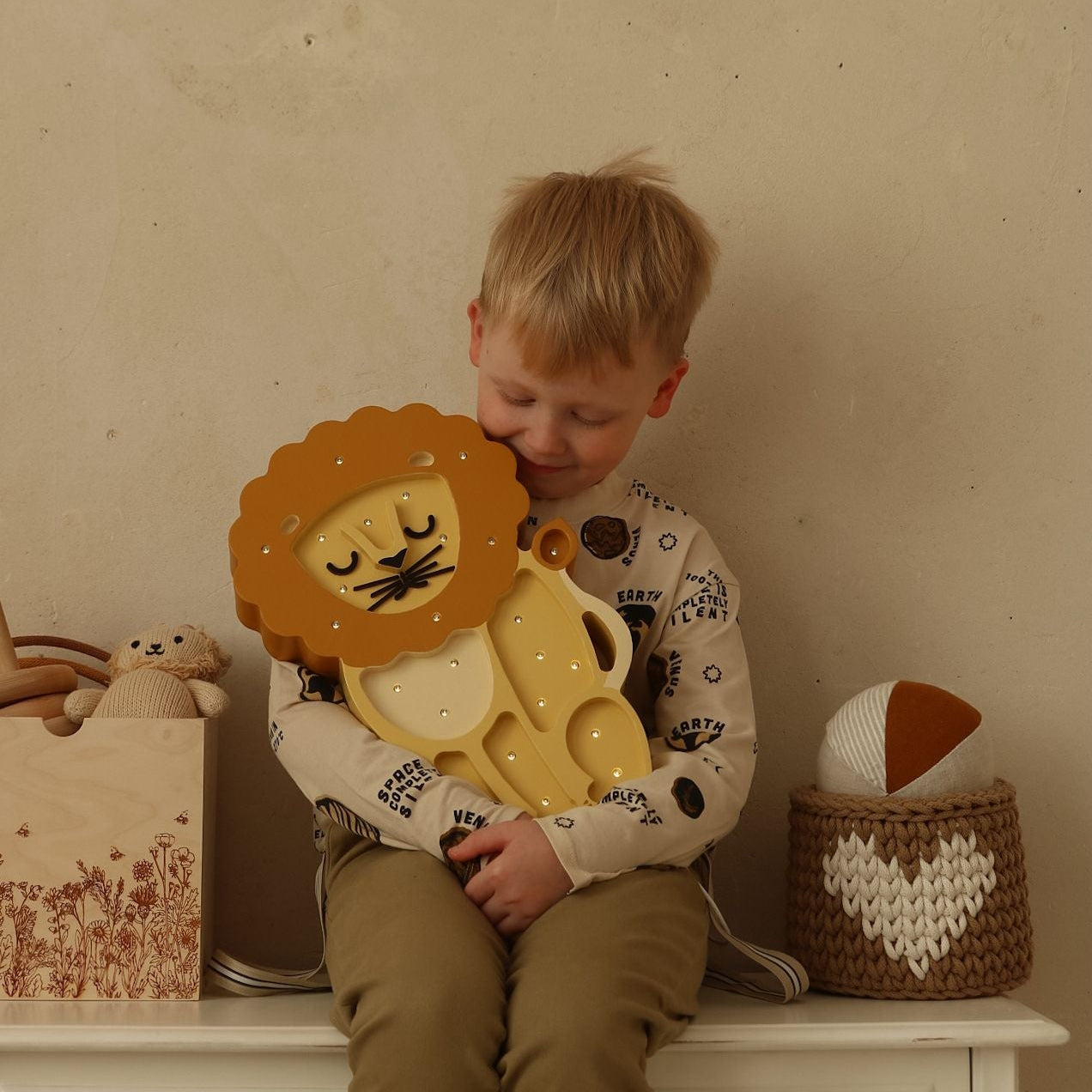Boy holding Little Lights Lion Lamp