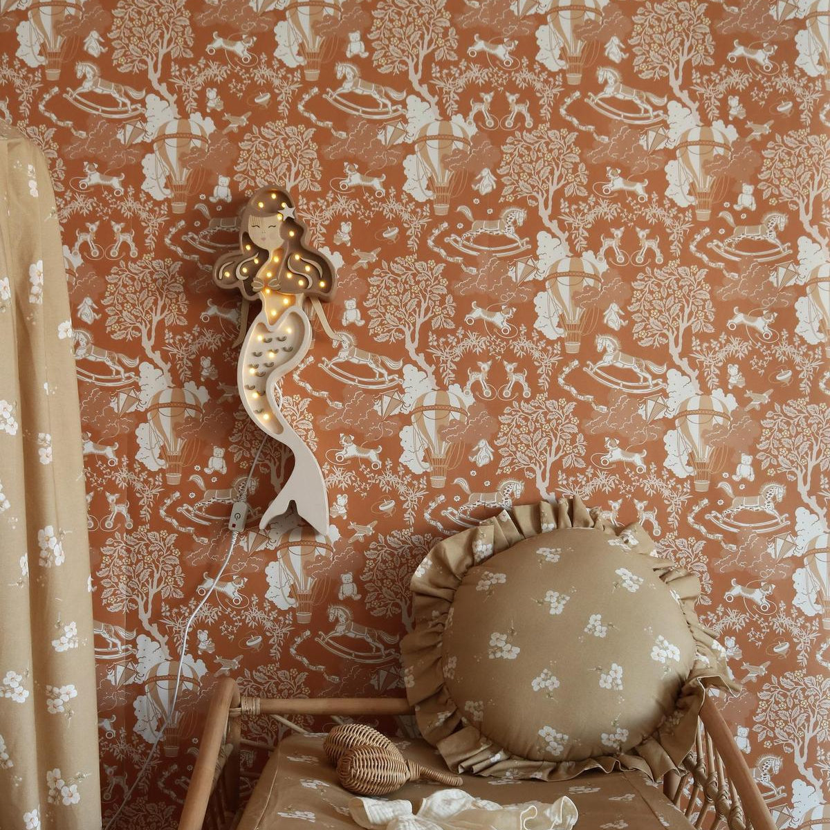 Little Lights beige Mermaid Lamp hanging near the children's changing table in a baby nursery